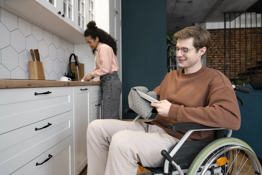 A man using a wheelchair working in his kitchen