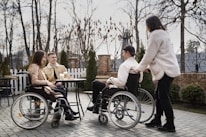A group of people in wheelchairs sitting around a table
