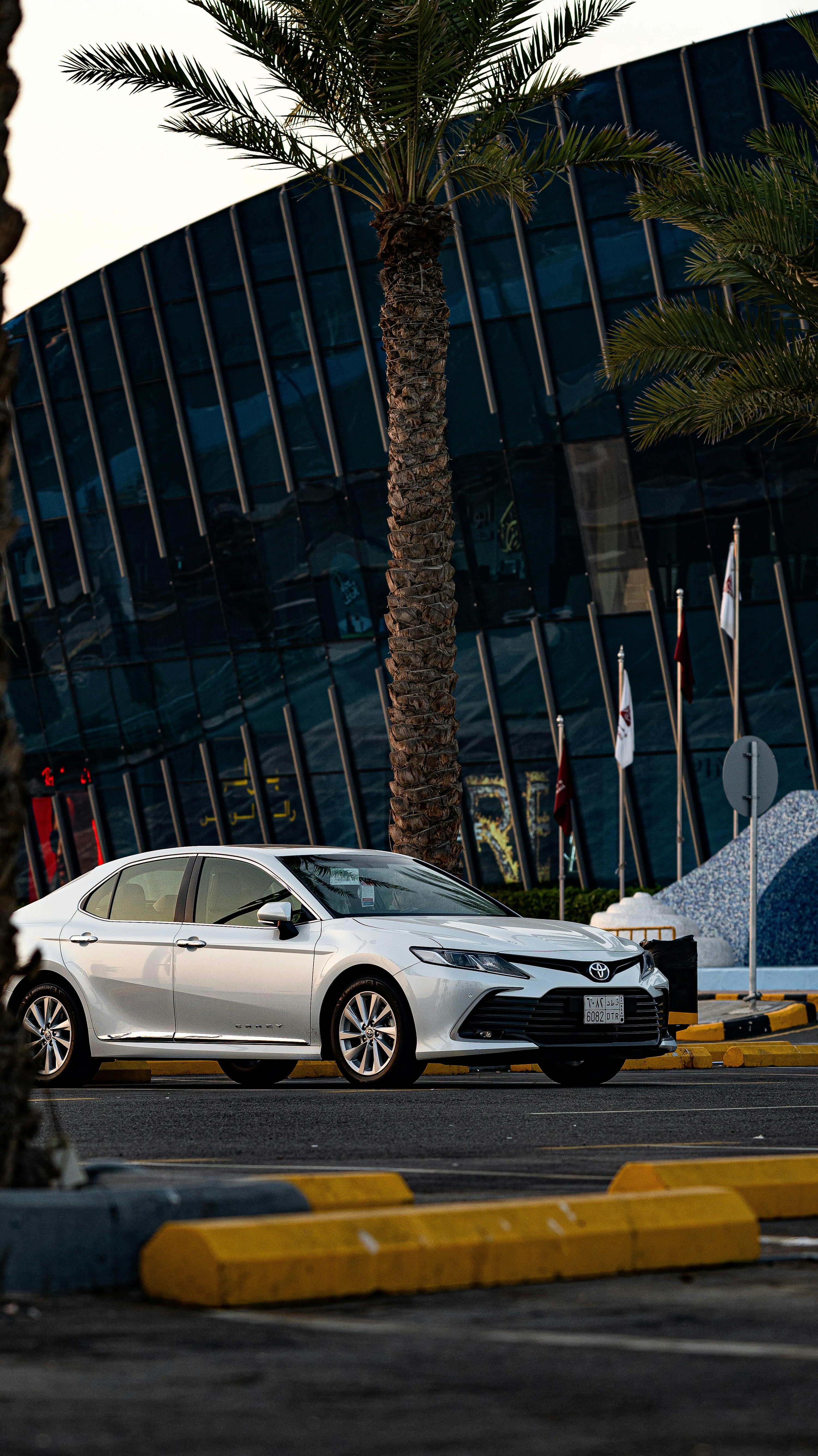A white car parked in front of a building