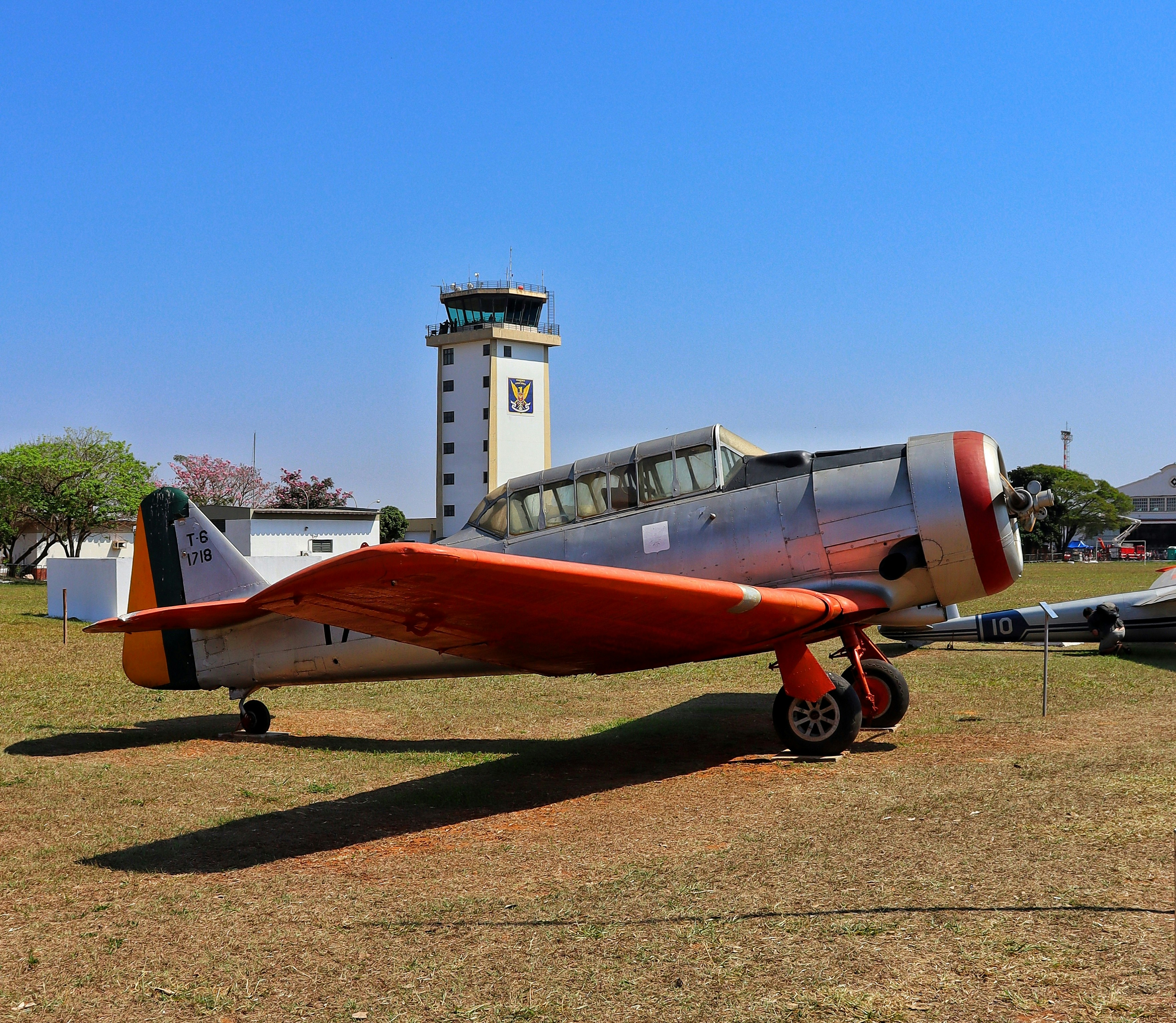 A small airplane sitting on top of a grass covered field, 