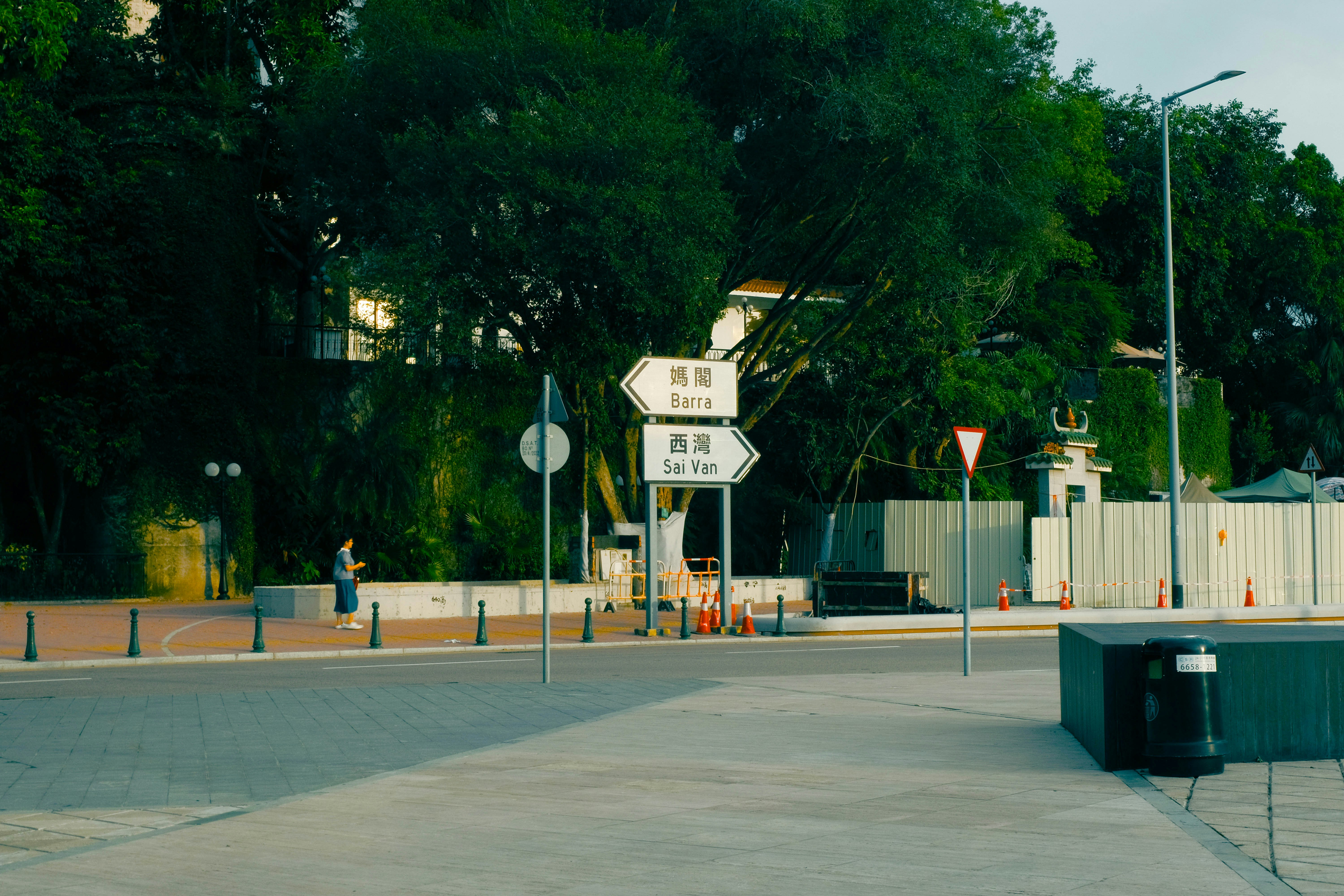 A street with a fence and a street sign