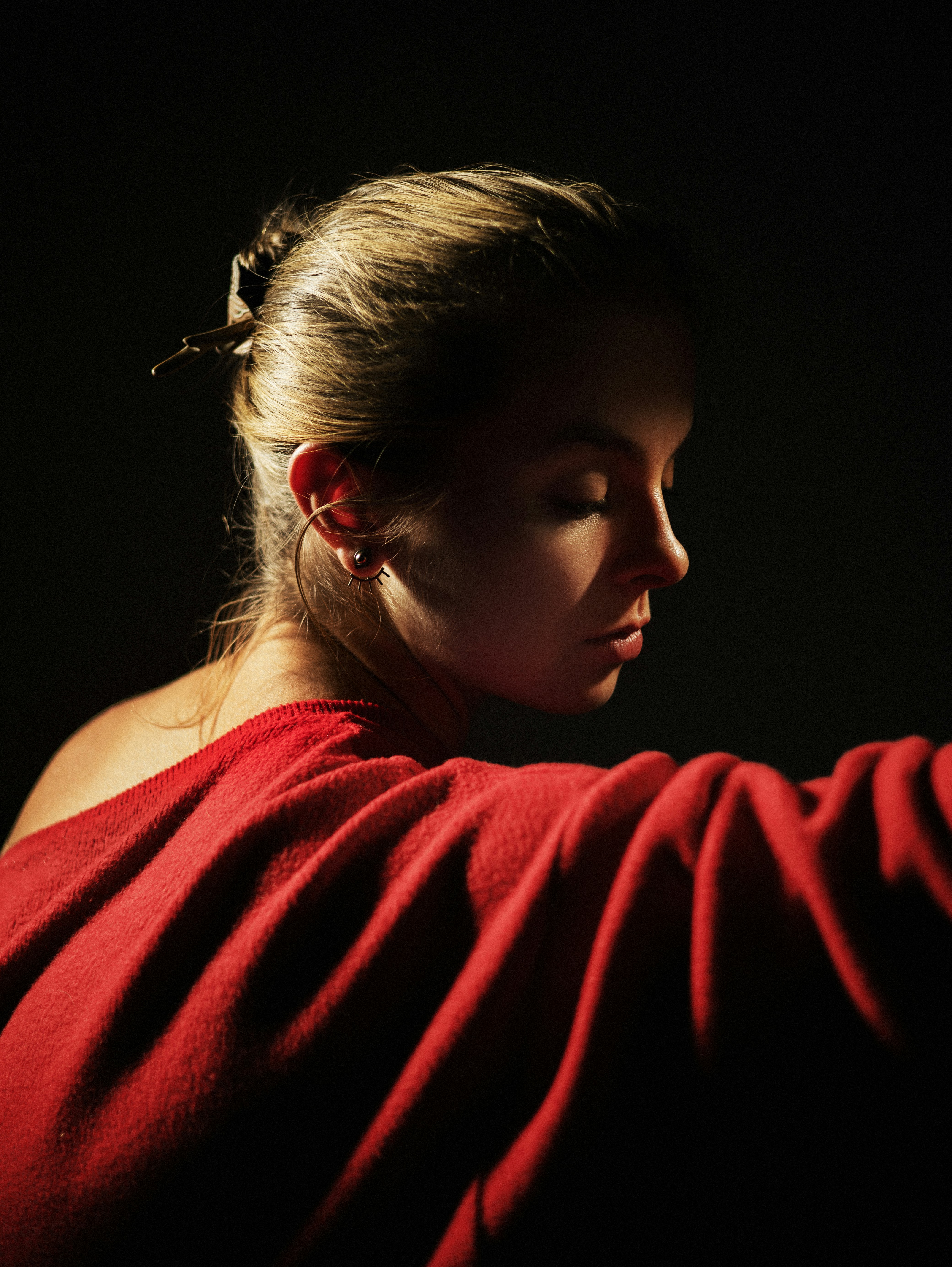 A woman in a red dress holding a cell phone