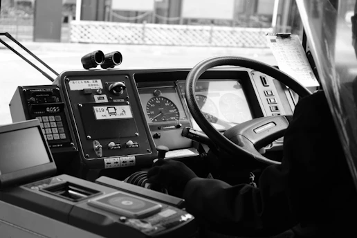 A black and white photo of a bus driver
