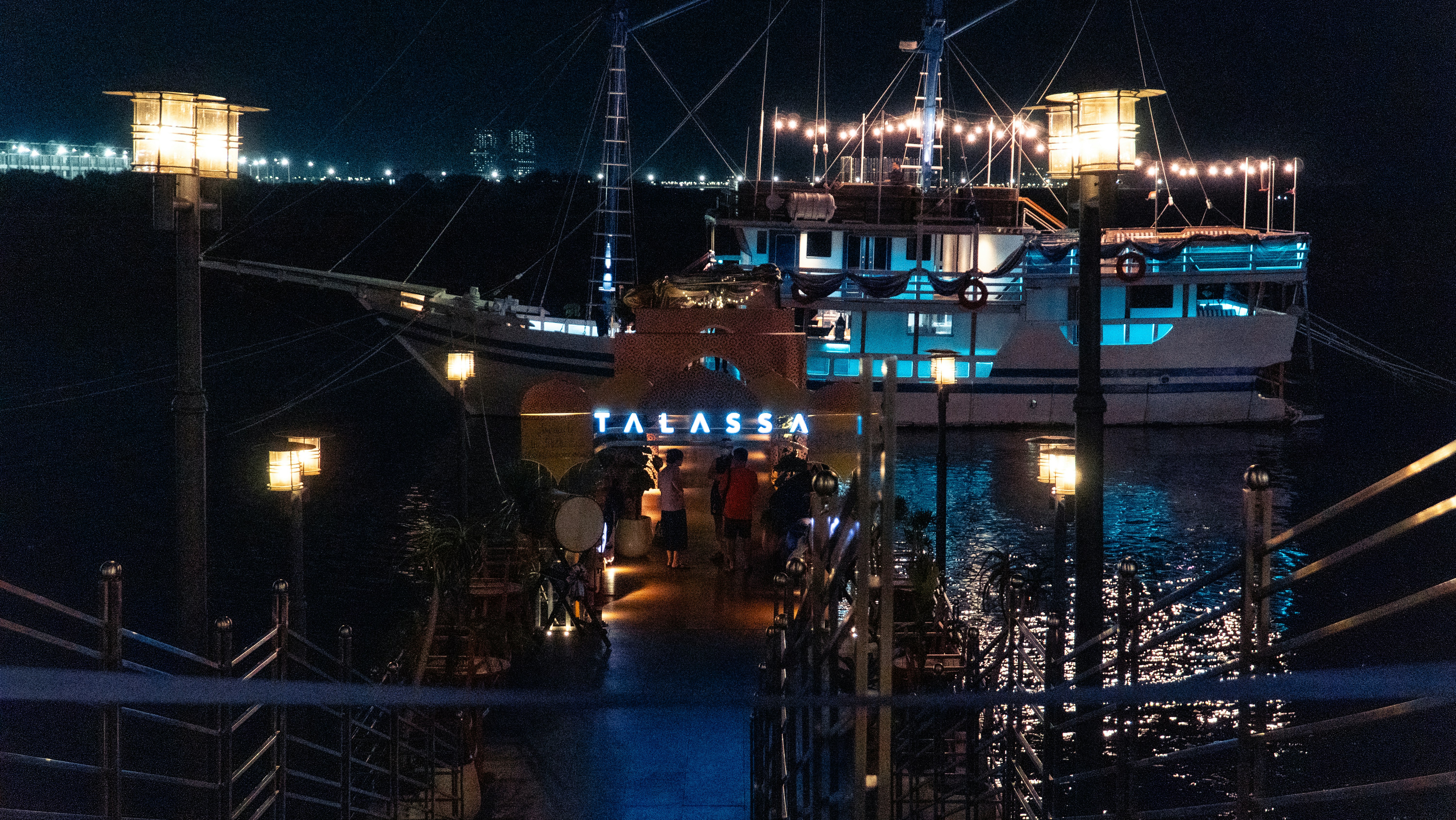 A boat docked at a dock at night, Night scene Talassa restaurant at Pantai Indah Kapuk Jakarta