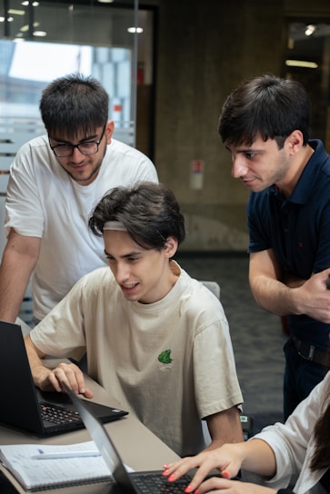 A group of people looking at a laptop