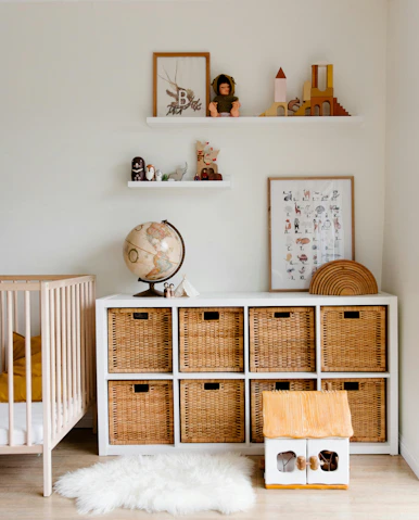 A baby's room with a crib, dresser, and crib bed