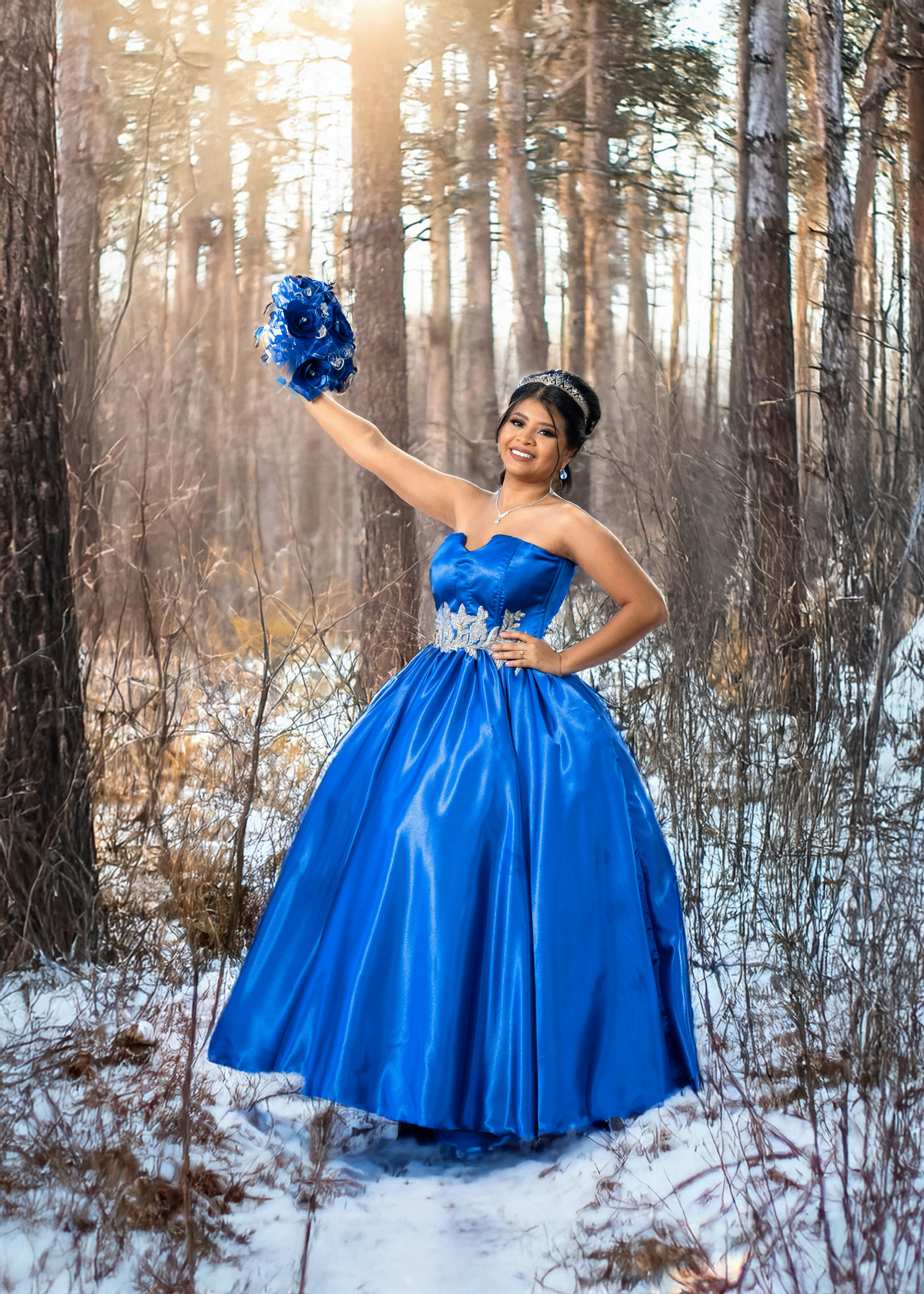 A woman in a blue dress standing in the snow