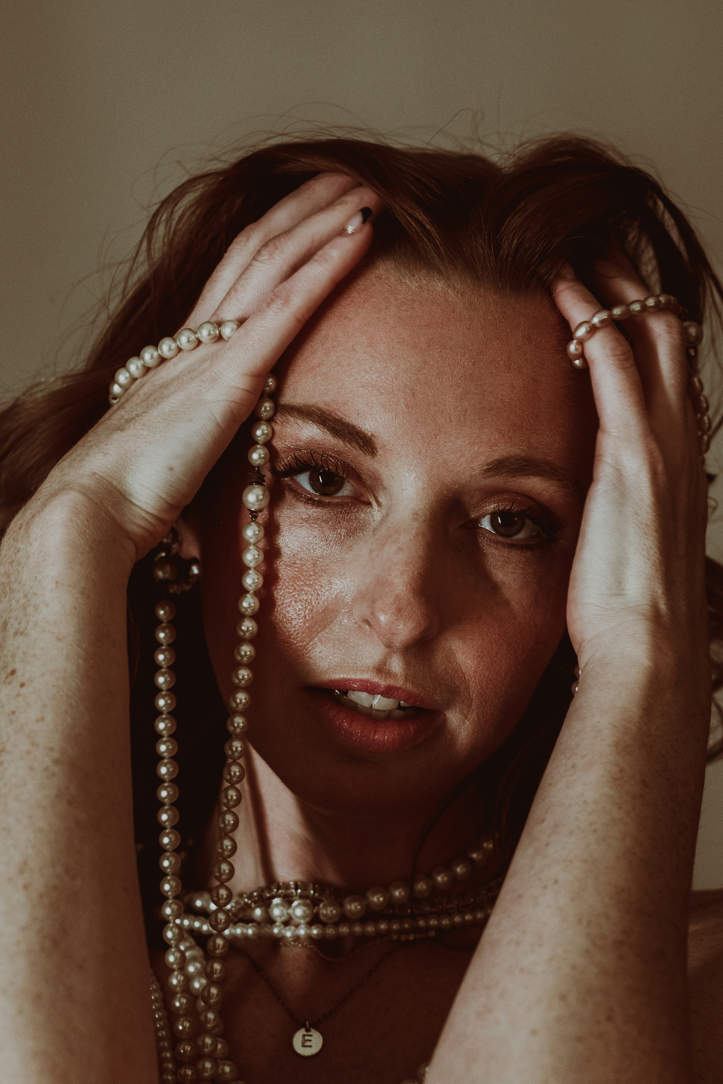 A woman holding her hands to her face