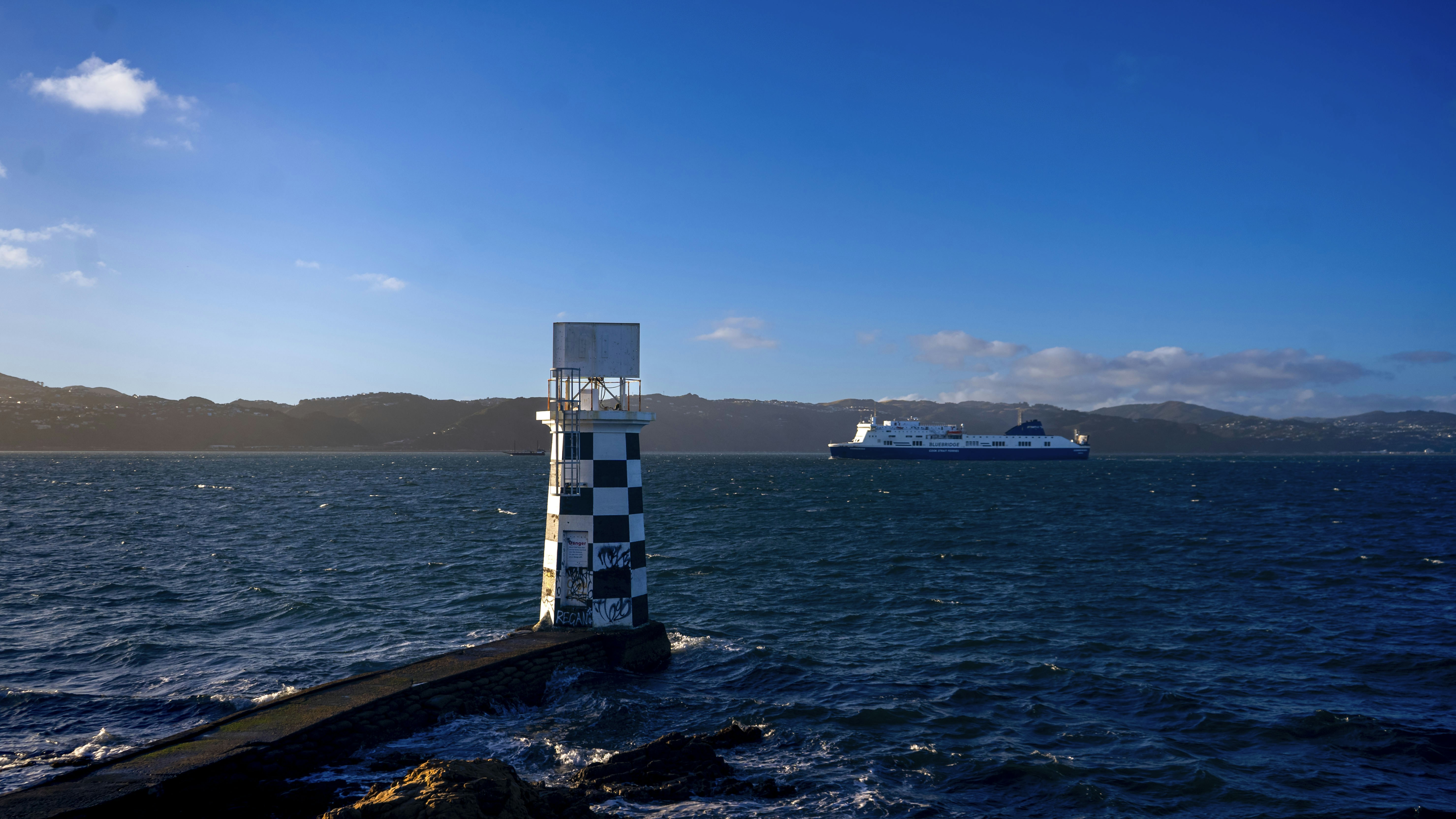 A large body of water with a boat in the distance