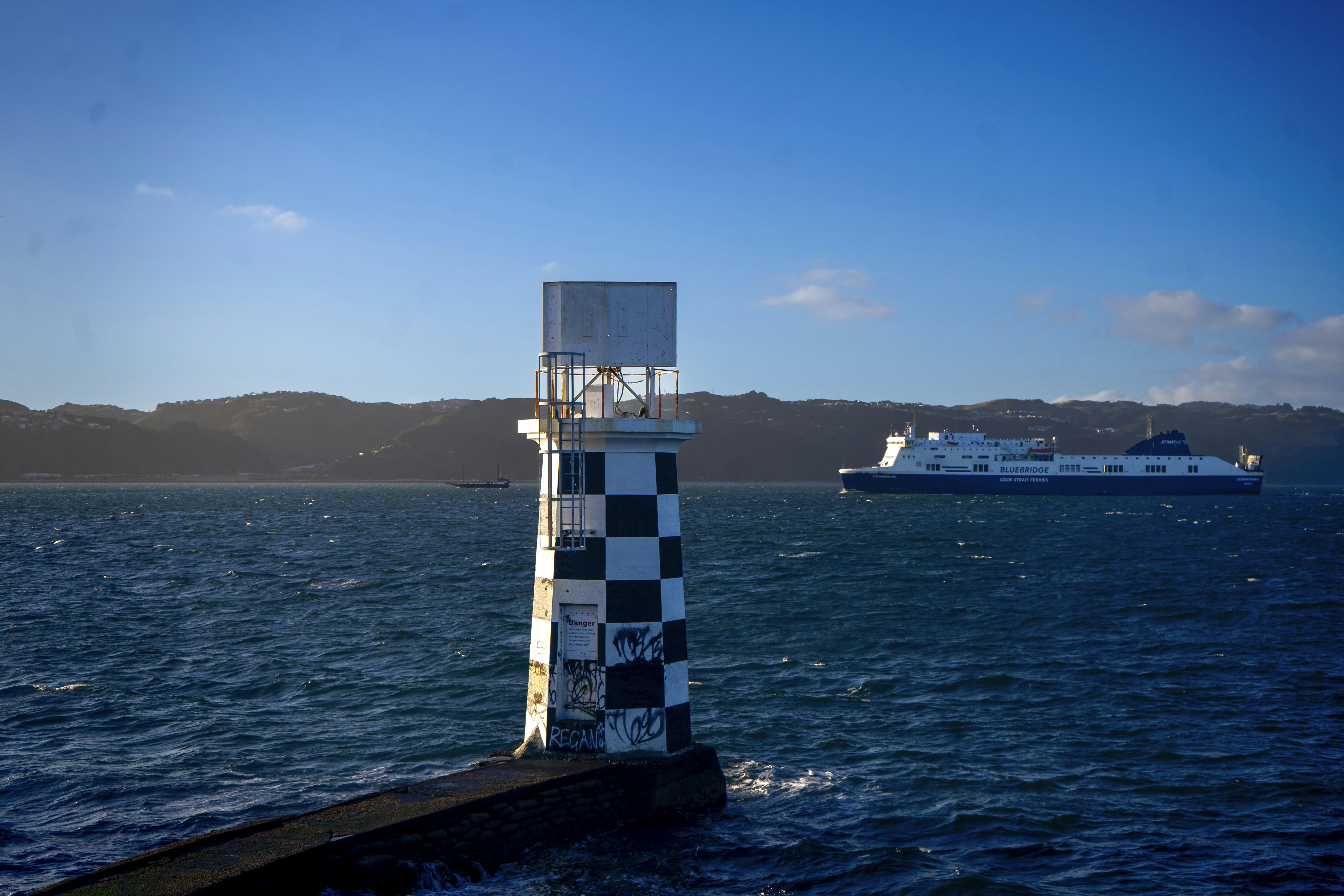 A lighthouse on the edge of a body of water