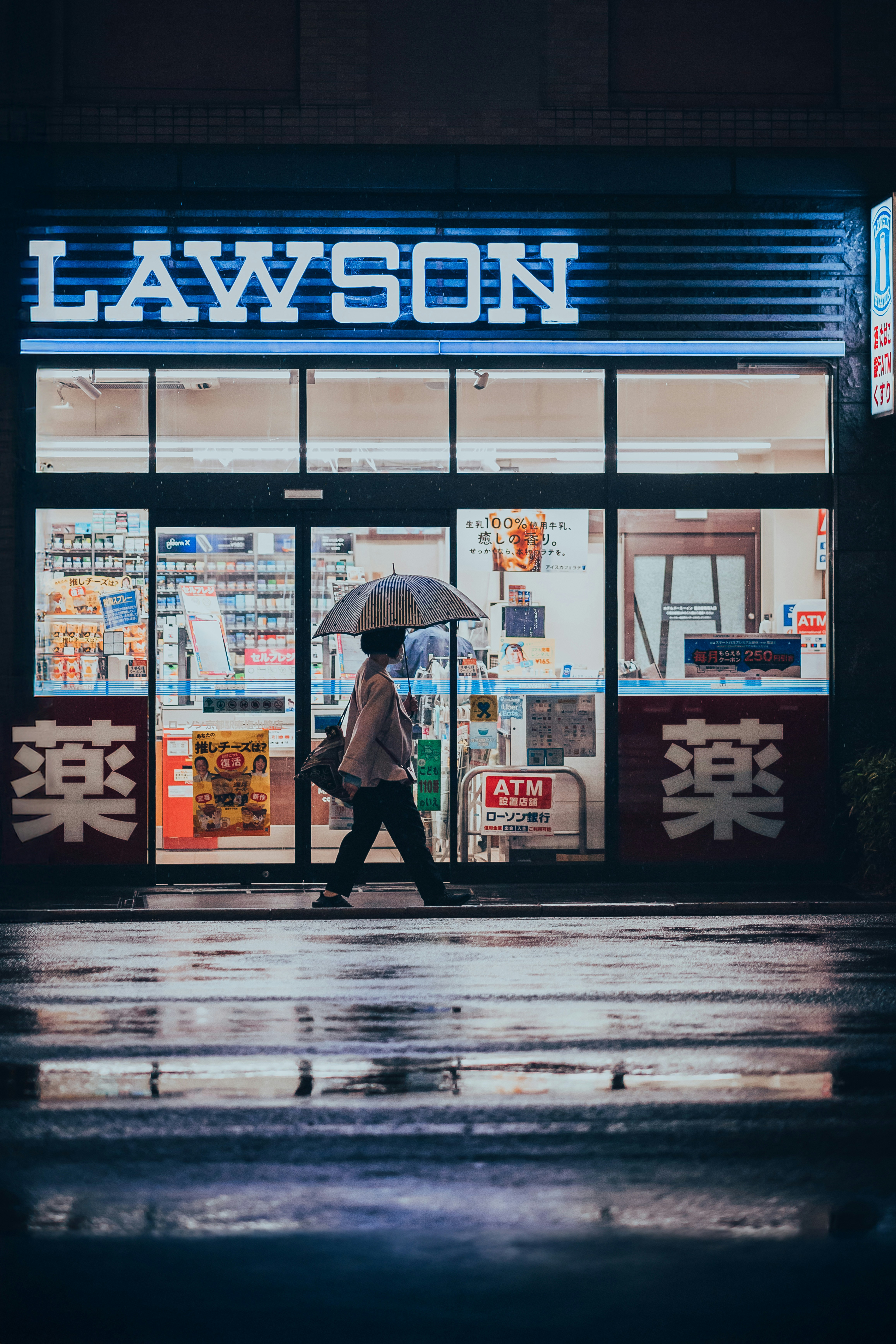A person walking down a street holding an umbrella