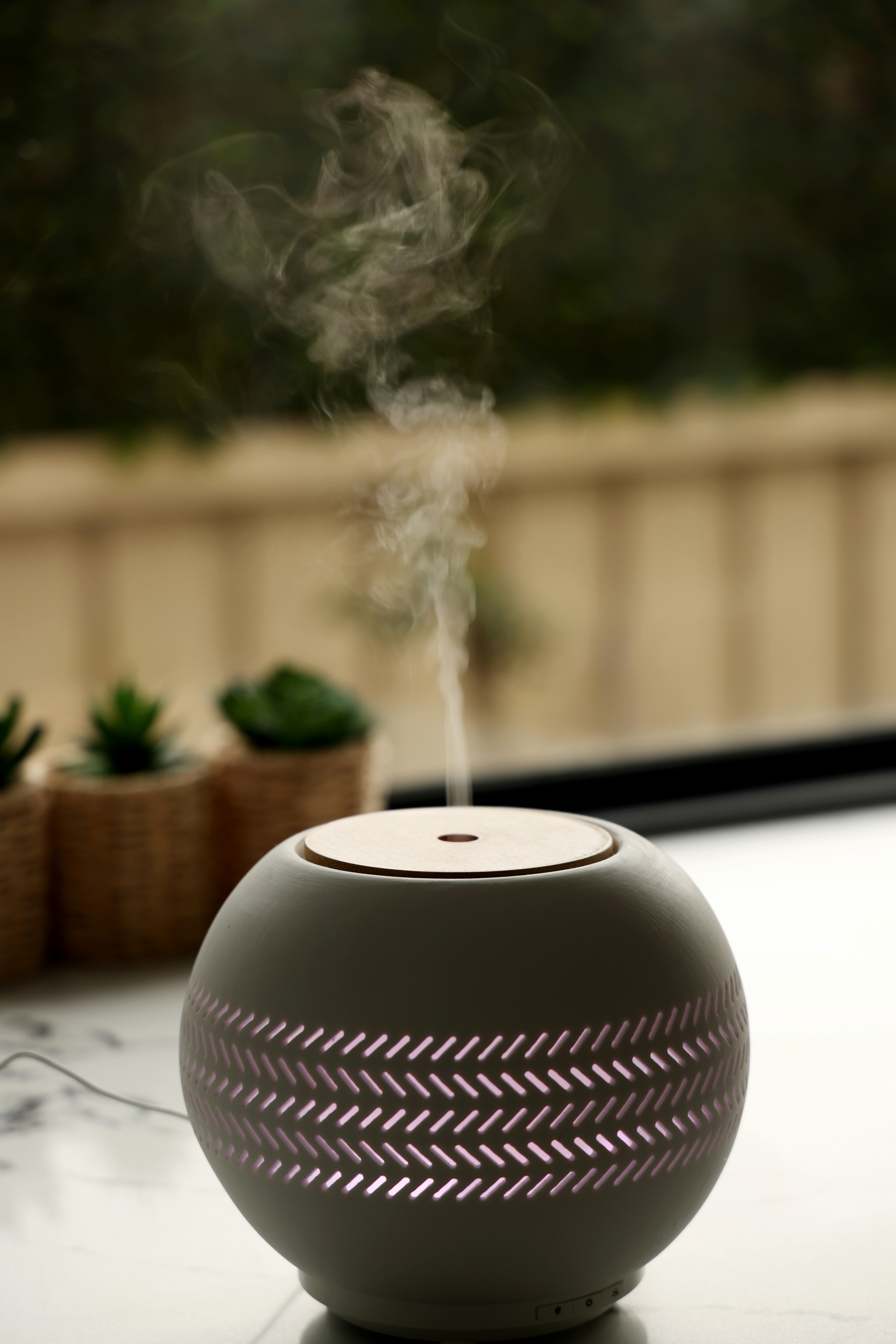 A white and black aroma diffuser sitting on top of a table photo – Free ...