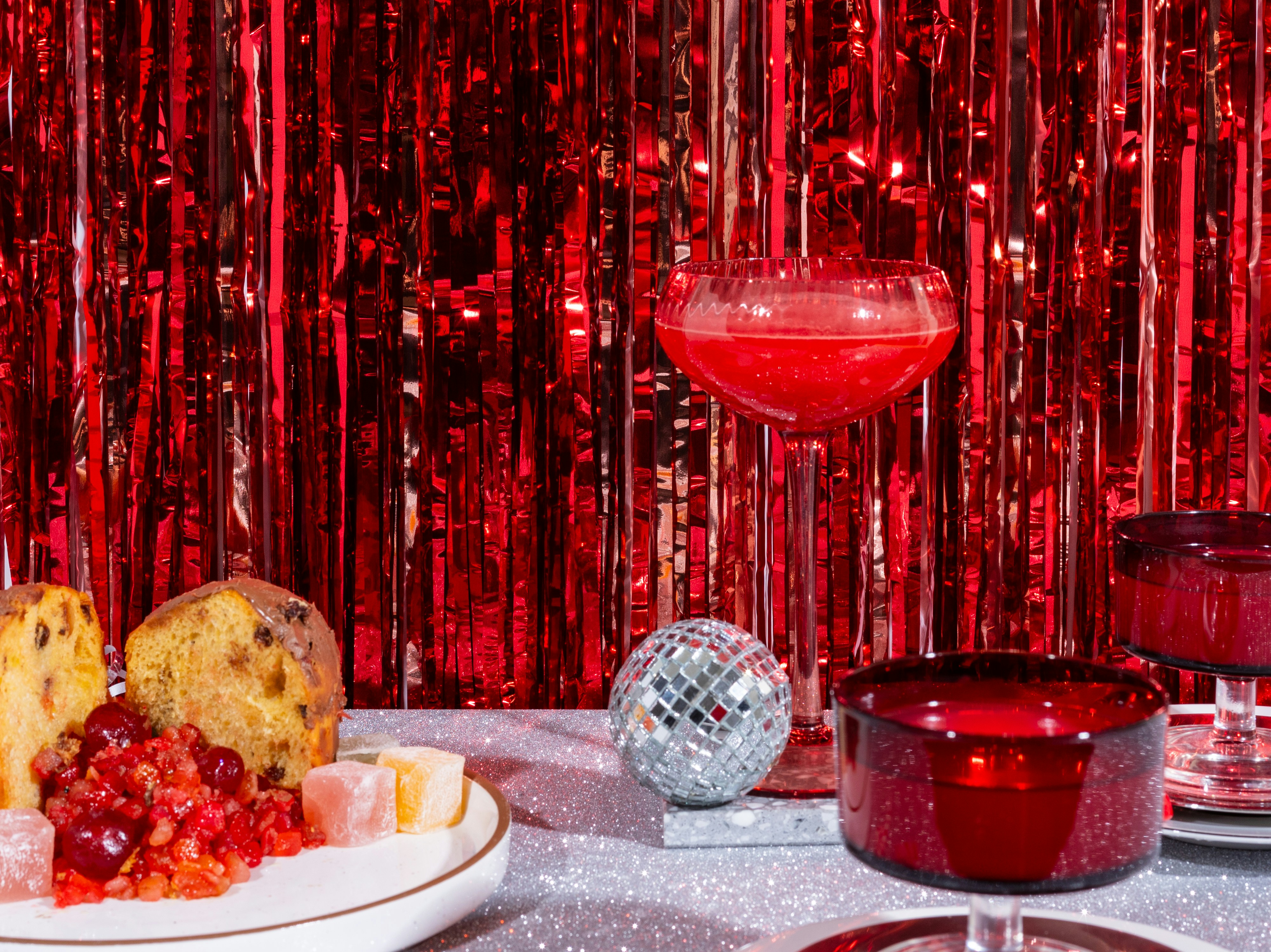 A table topped with a plate of food and a glass of wine