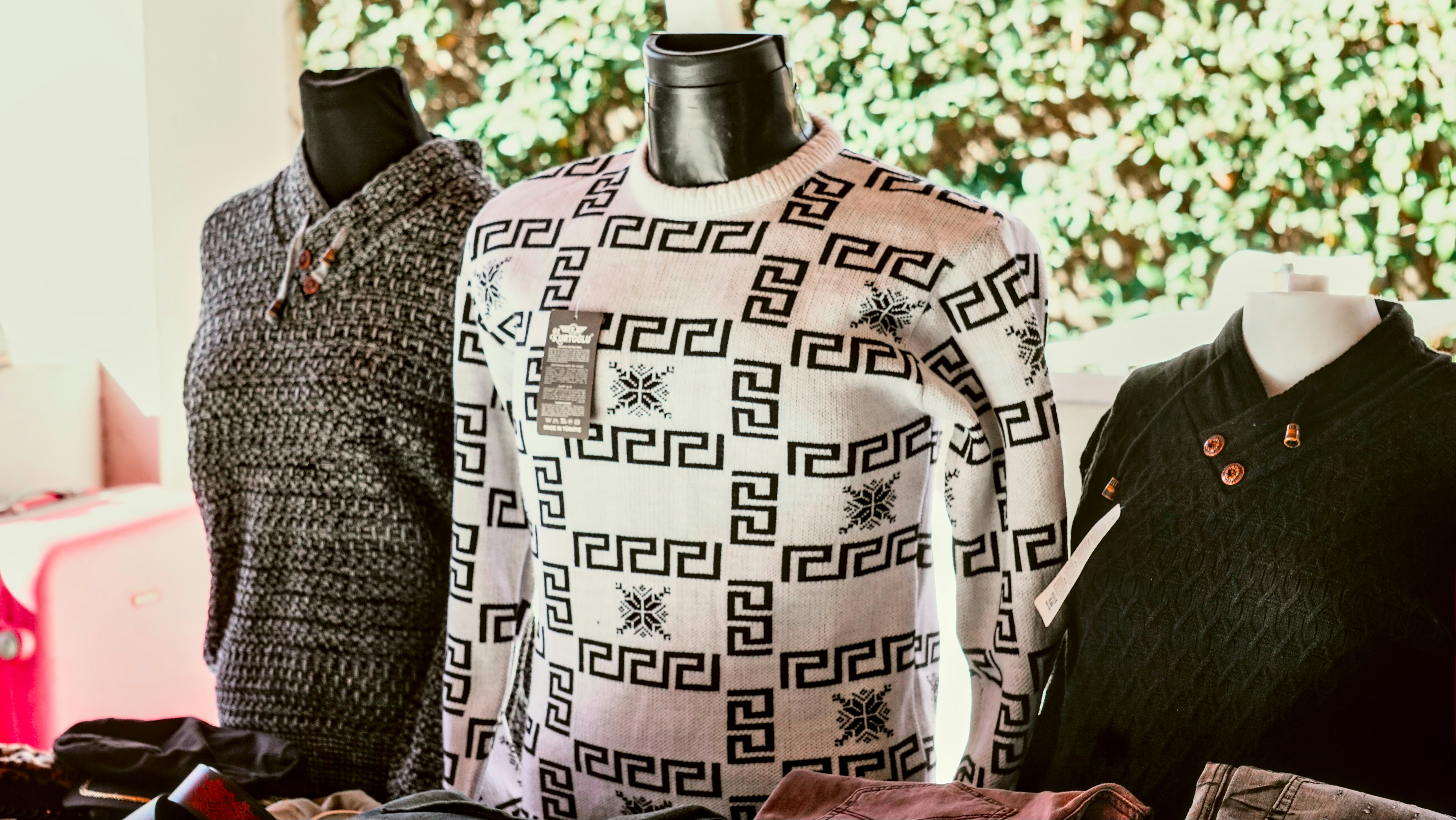 Three mannequins are sitting next to each other on a table