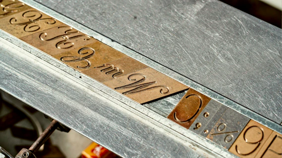 A close up of a metal table with writing on it