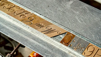 A close up of a metal table with writing on it