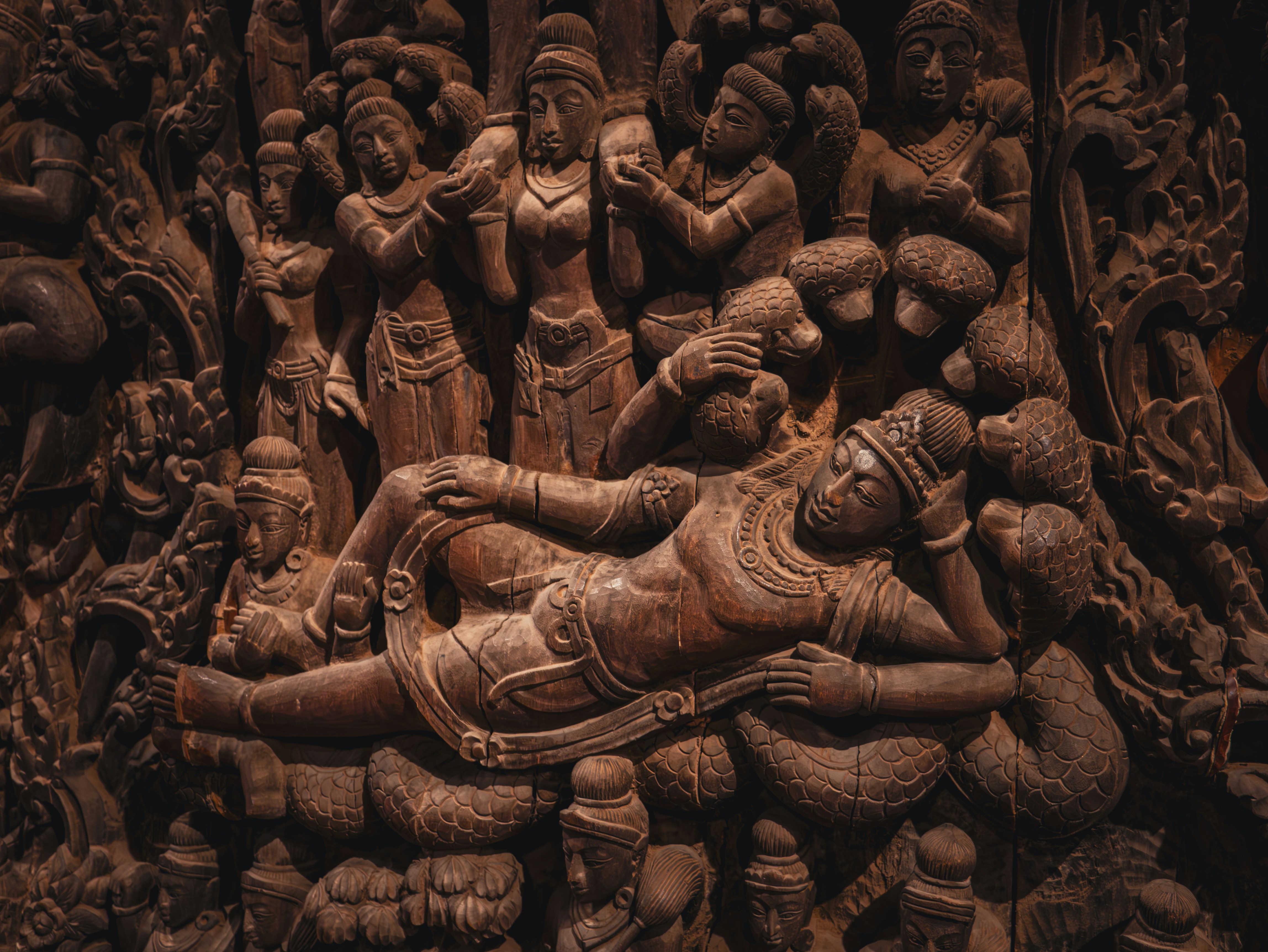 A carving of a woman laying on a man's chest