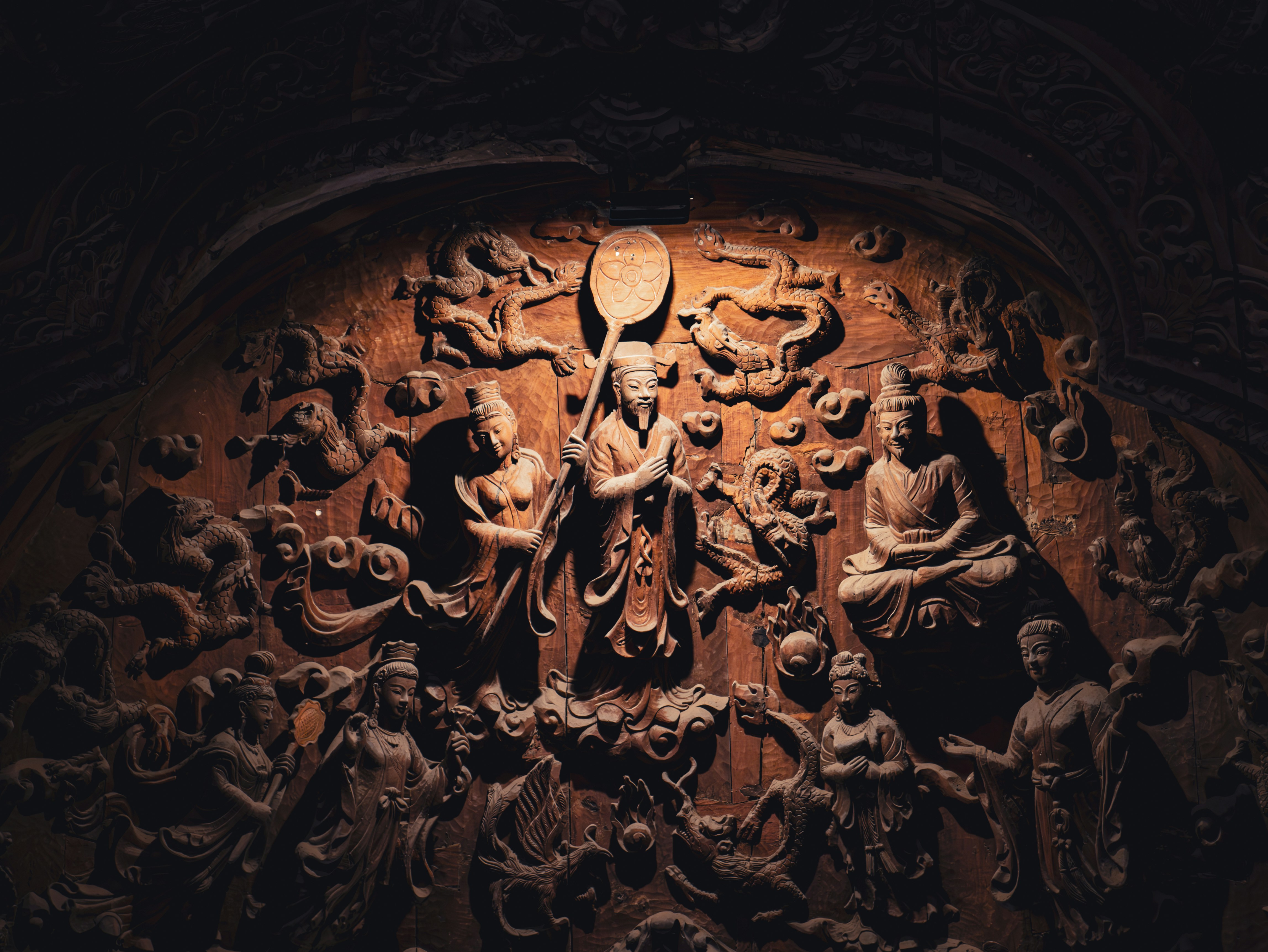 A carving of a person surrounded by other figures