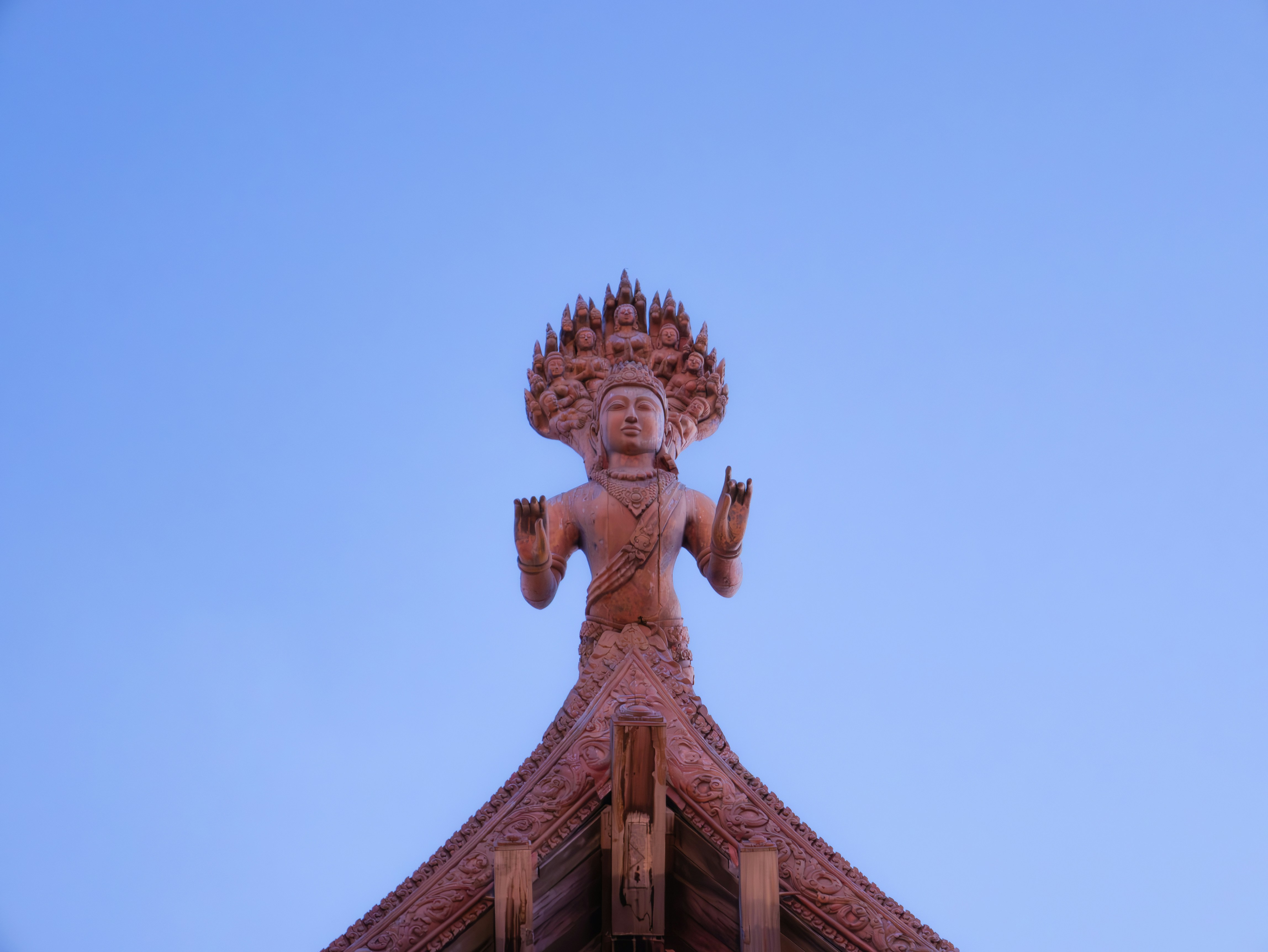 A tall building with a statue on top of it