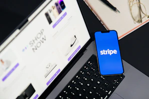 A cell phone sitting on top of a laptop computer
