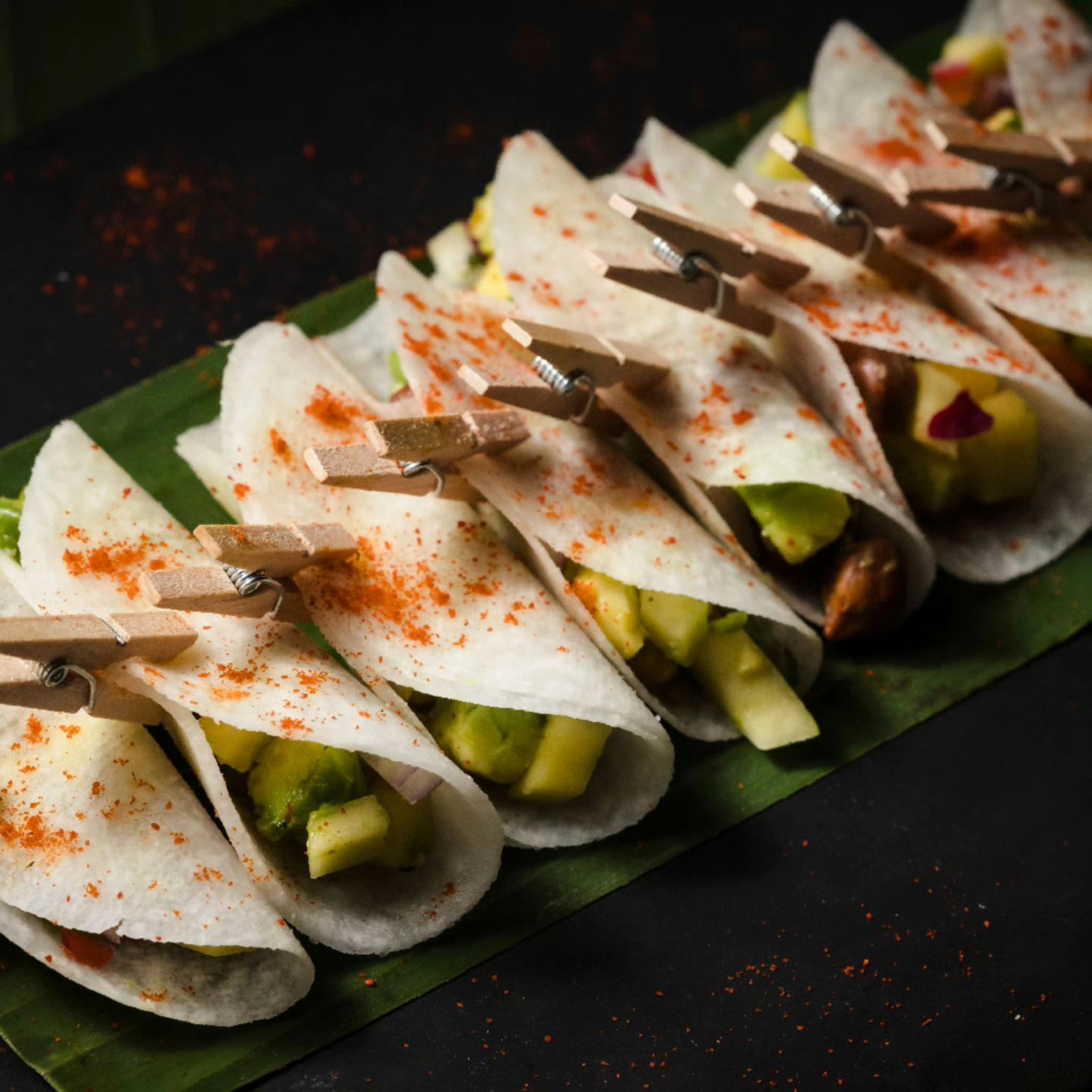 A green plate topped with lots of food on top of a table
