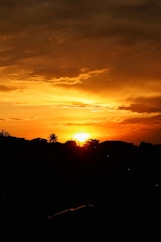 The sun is setting over a mountain range