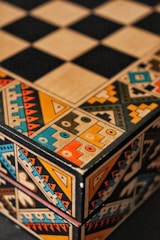 A colorful box sitting on top of a checkered floor
