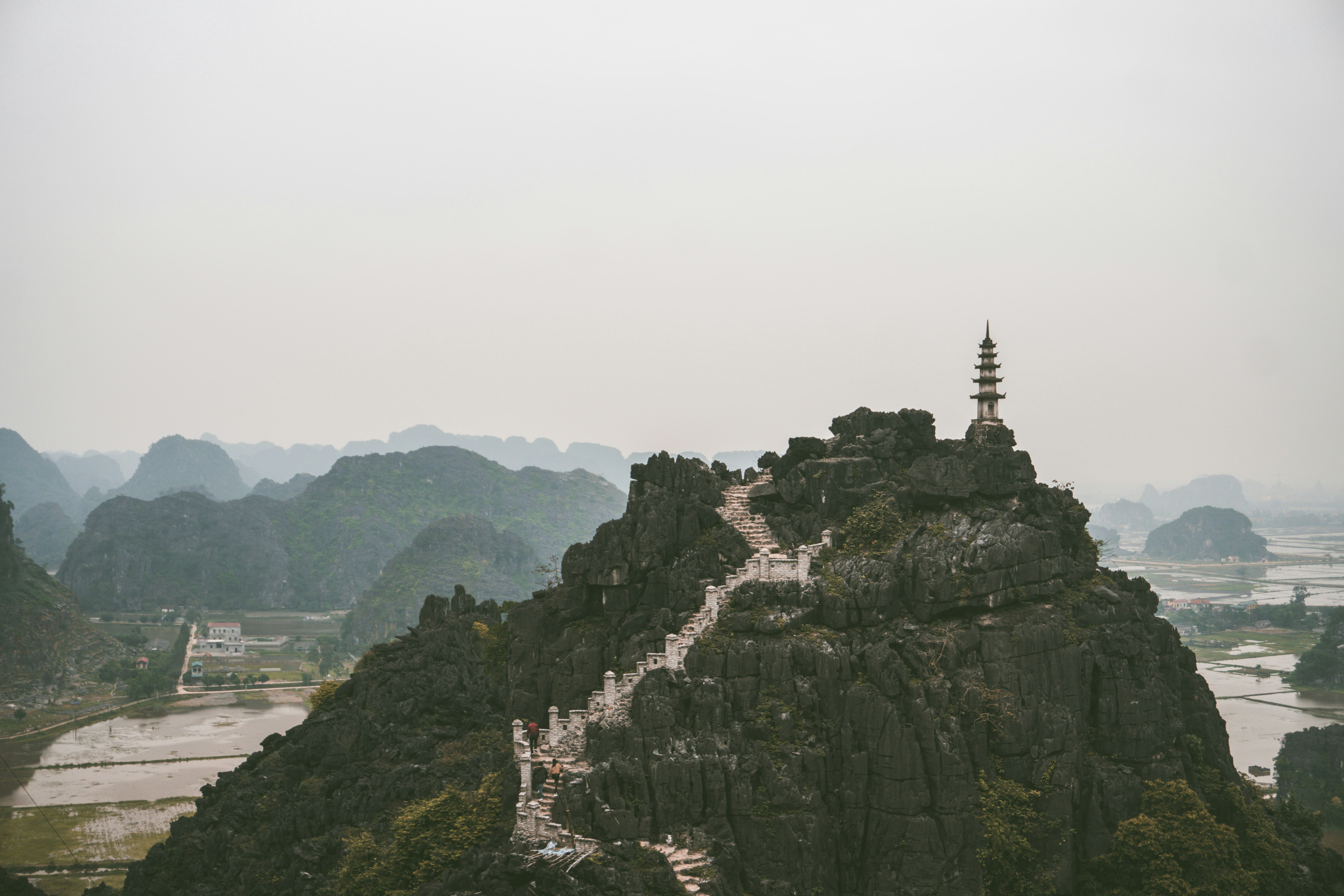 A mountain with a pagoda on top of it