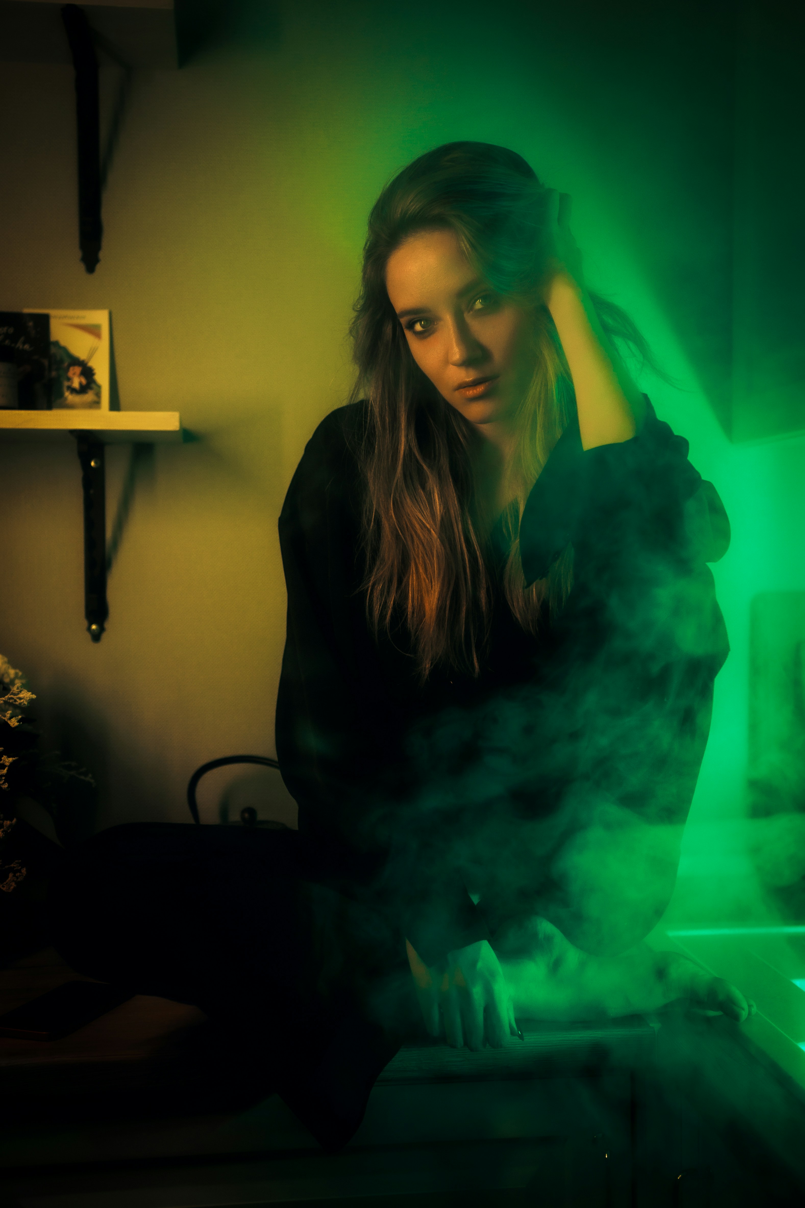 A woman sitting on a bed in front of a laptop computer