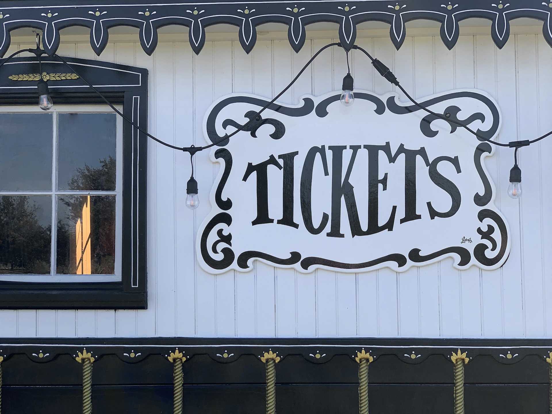 A sign on the side of a building that says tickets