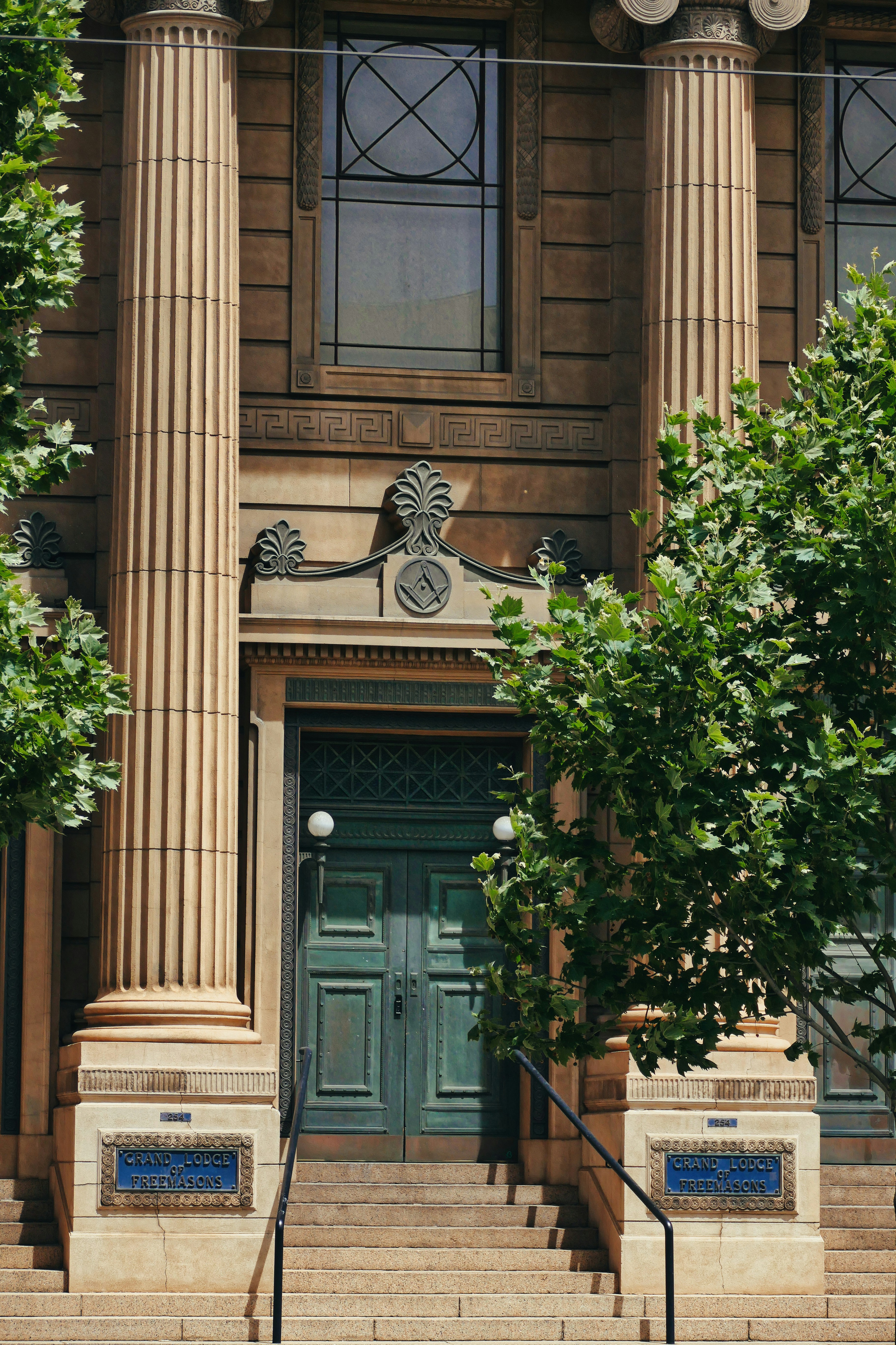 A large building with columns and a clock on the front of it
