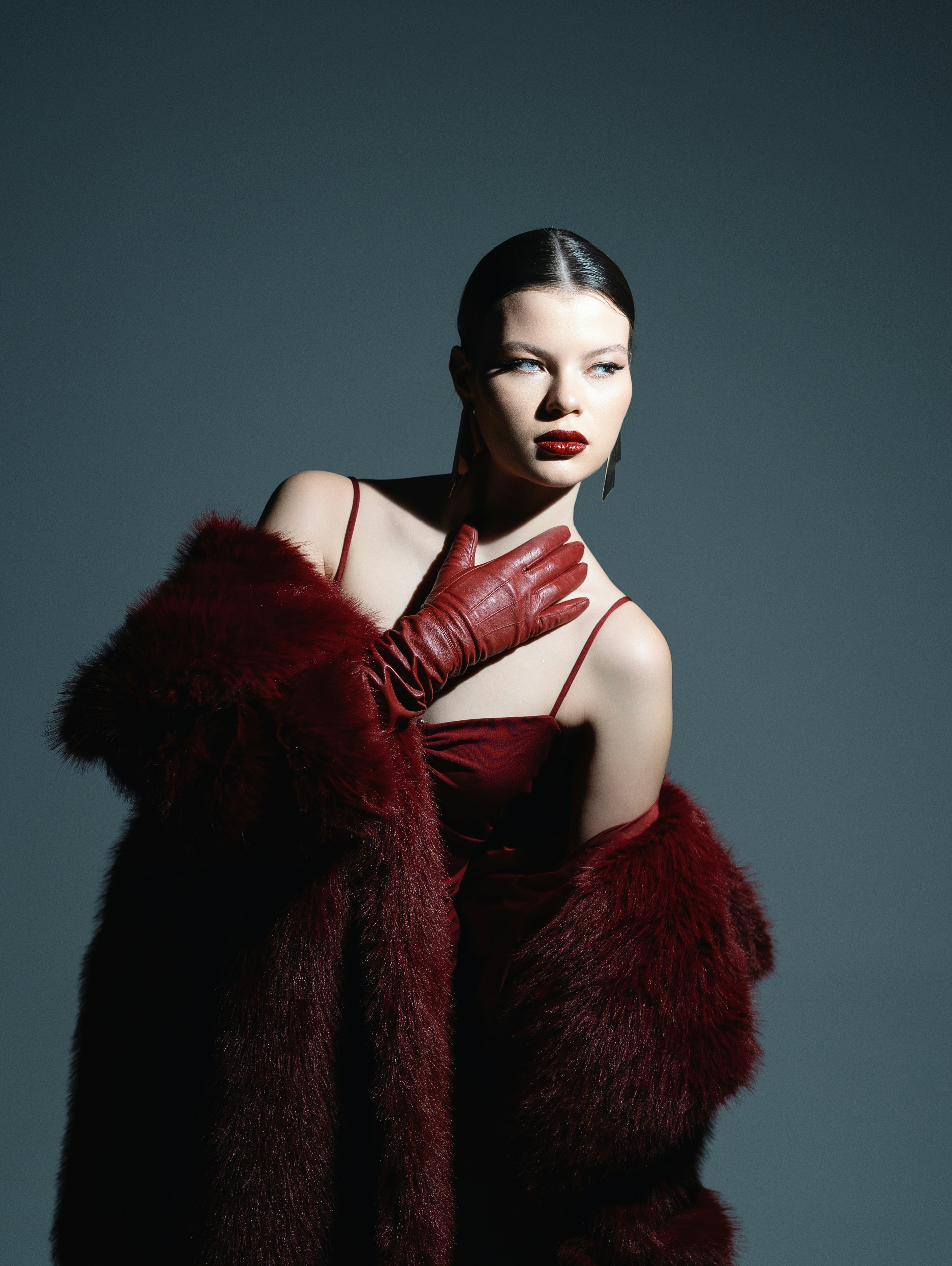 A woman in a red dress and red gloves