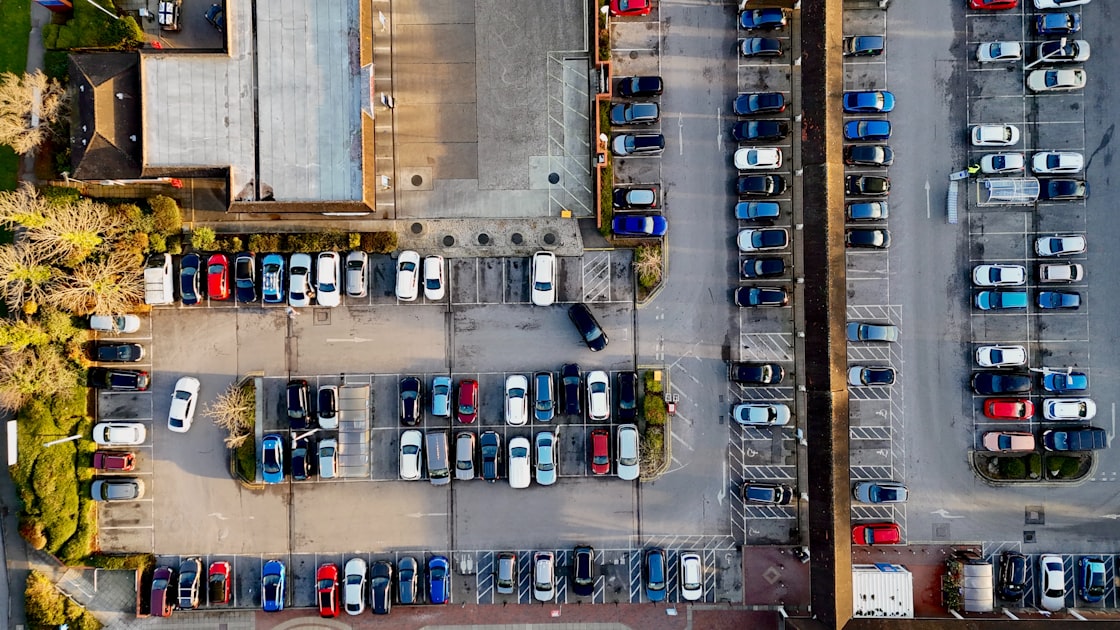 An aerial view of a parking lot full of cars