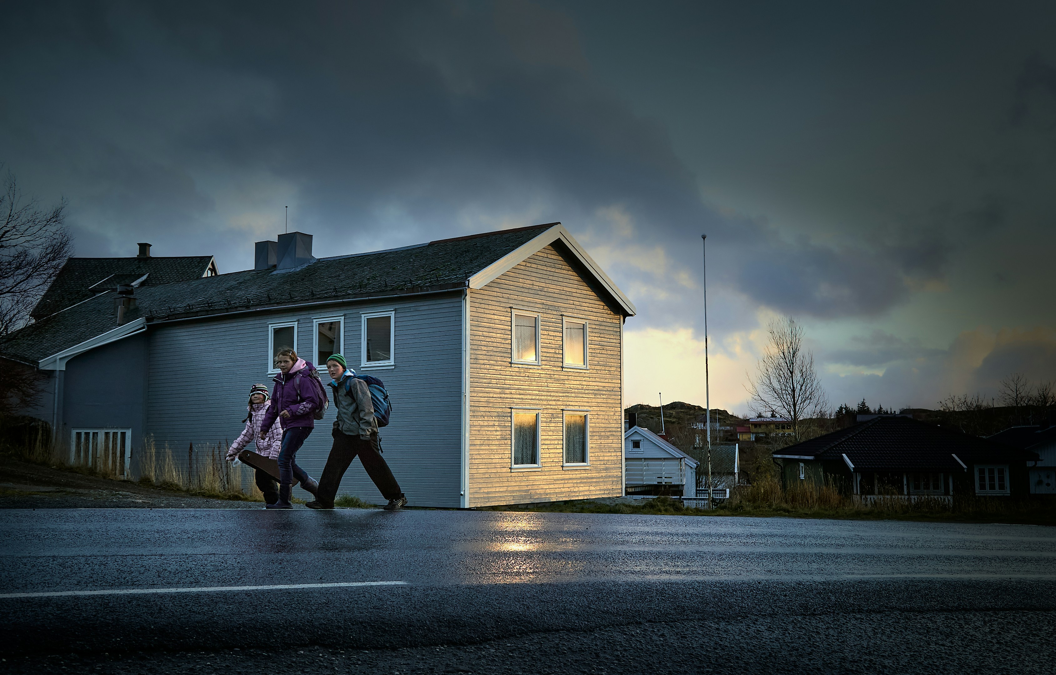 A couple of people walking across a street