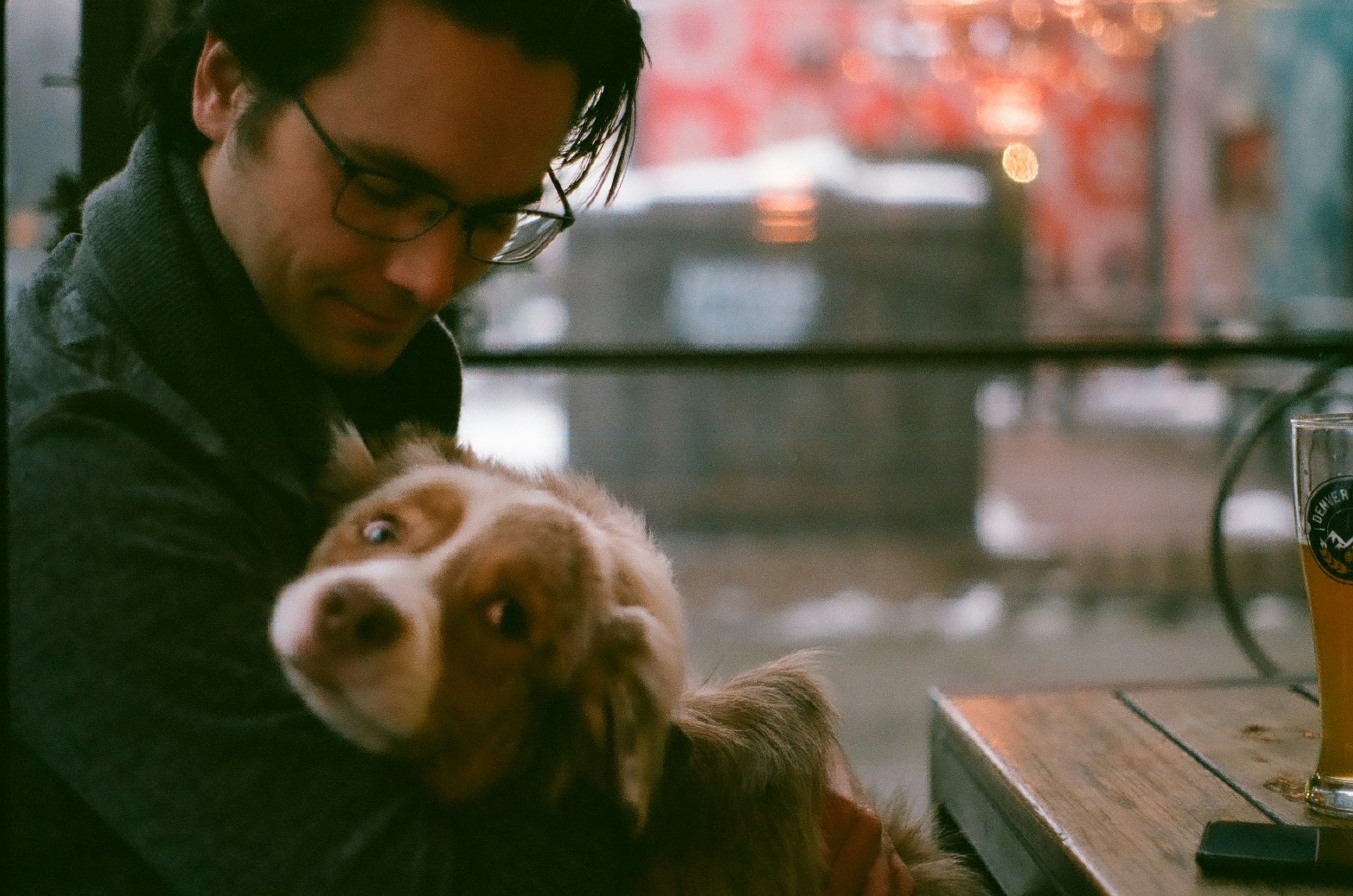 A man sitting at a table with a dog photo – Free Winter Image on Unsplash