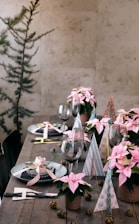 A wooden table topped with lots of pink flowers