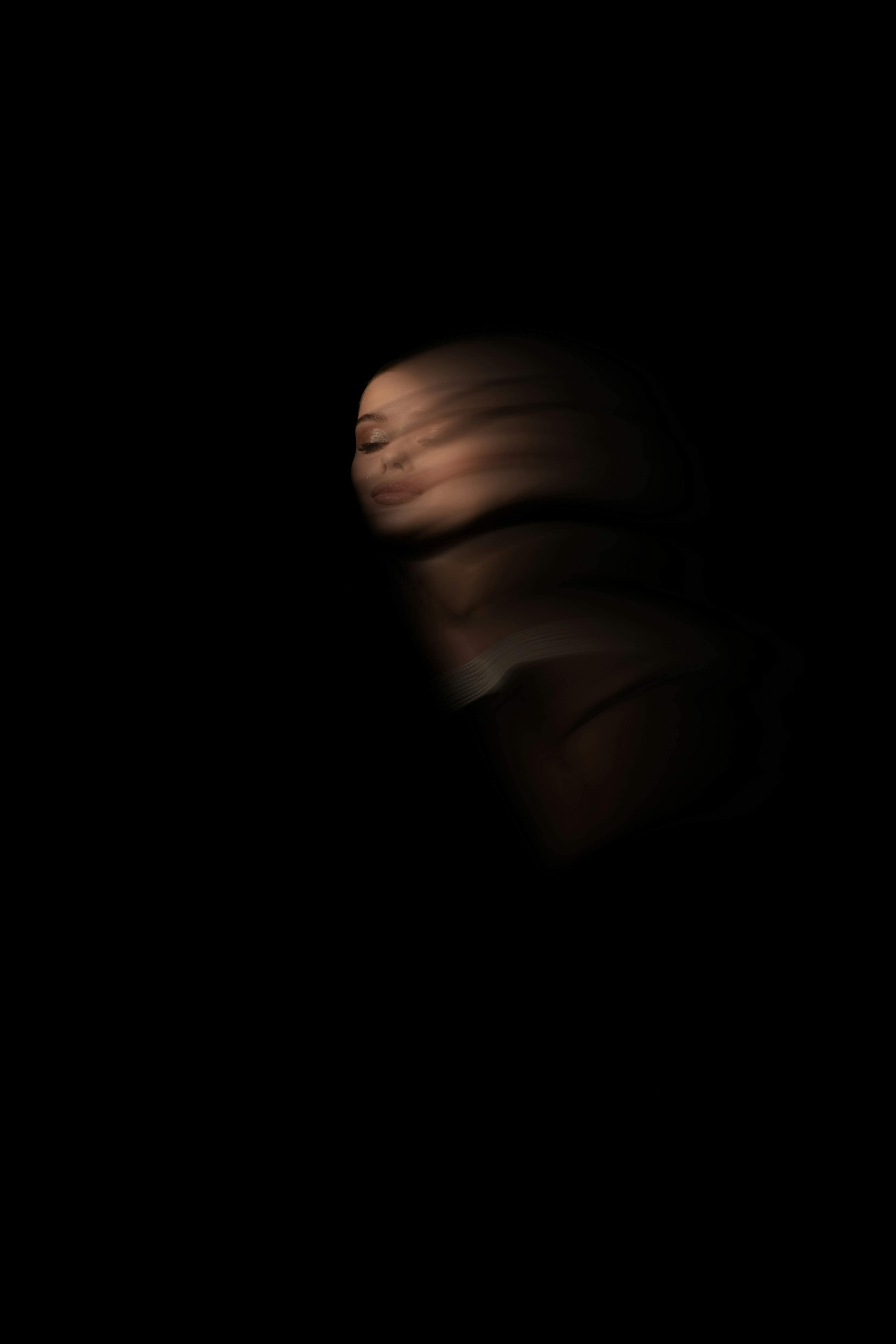 A blurry photo of a person's face in the dark