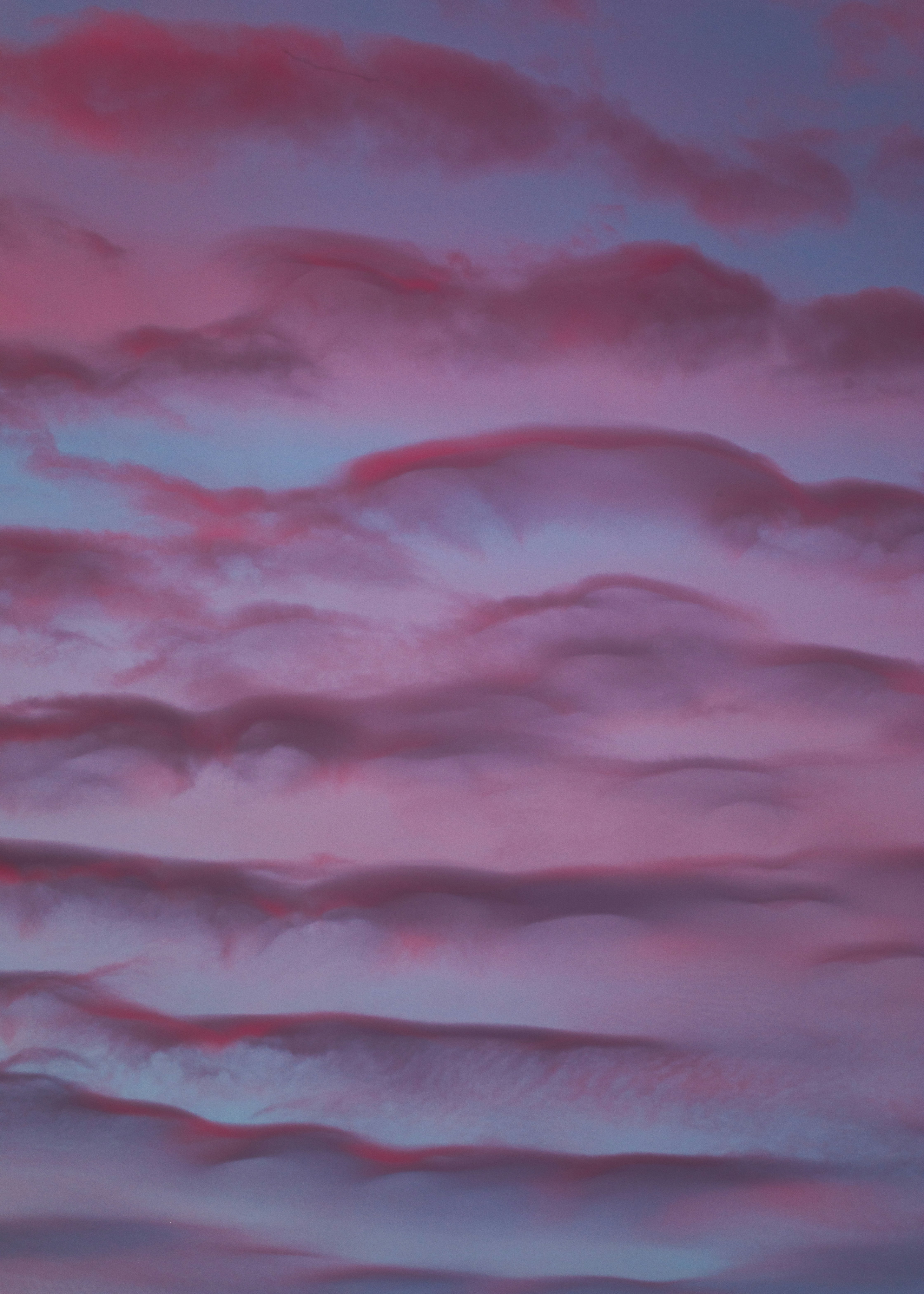 A pink and blue sky with some clouds