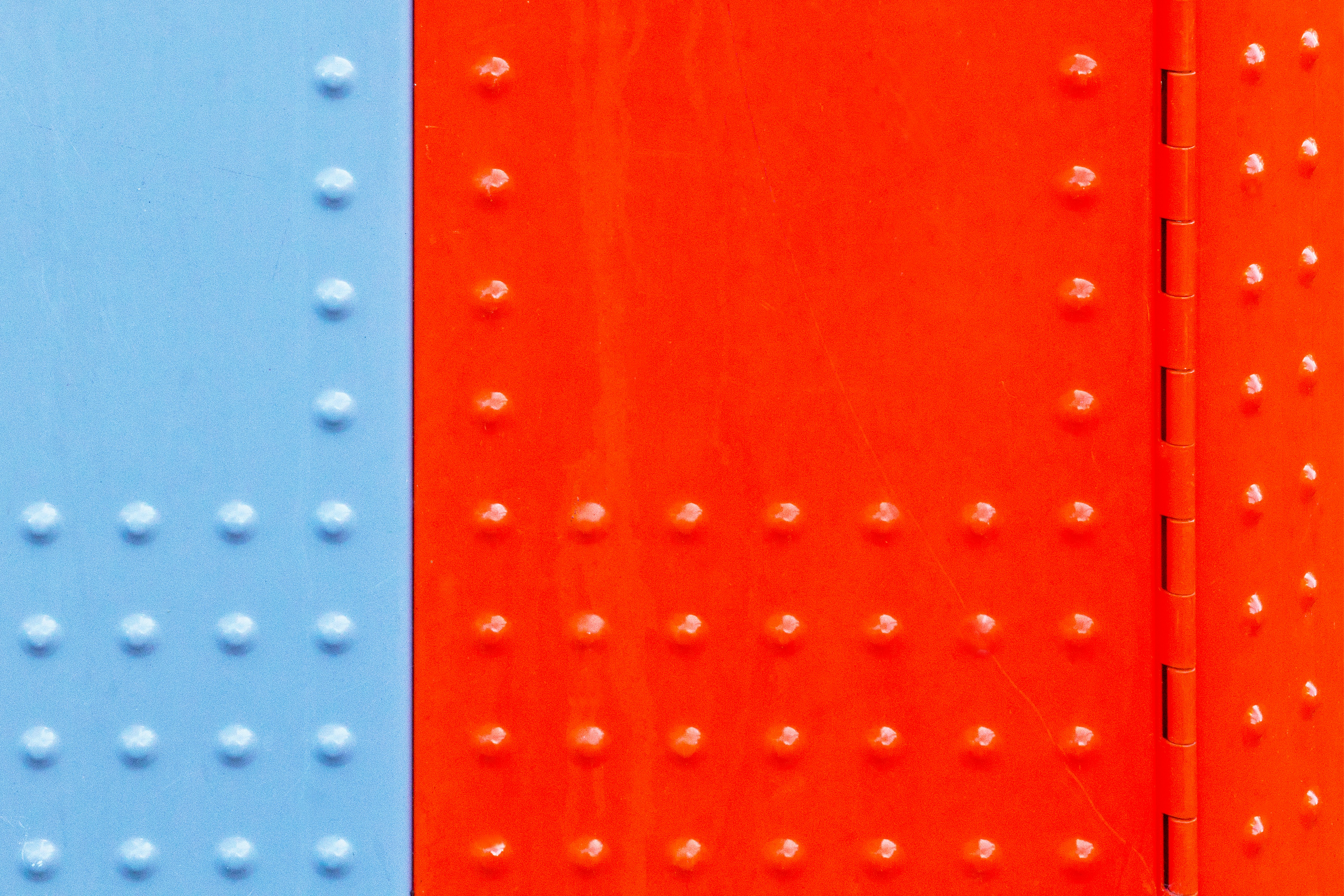 Close view of a red and blue architectural surface