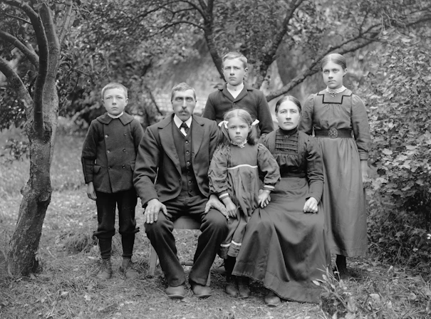 A formal family portrait in an outdoor setting.