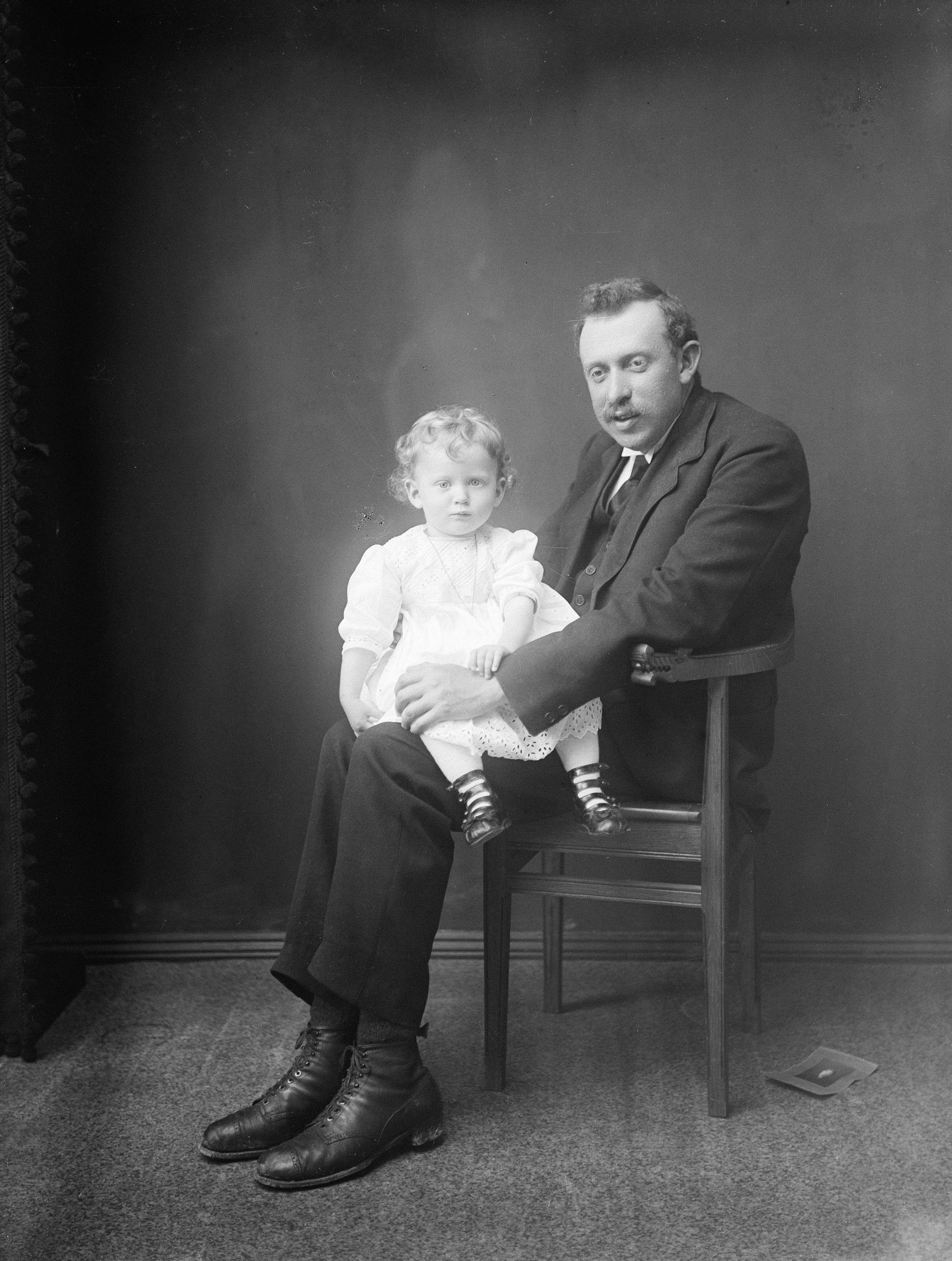 Man in suit holding a young child on his lap