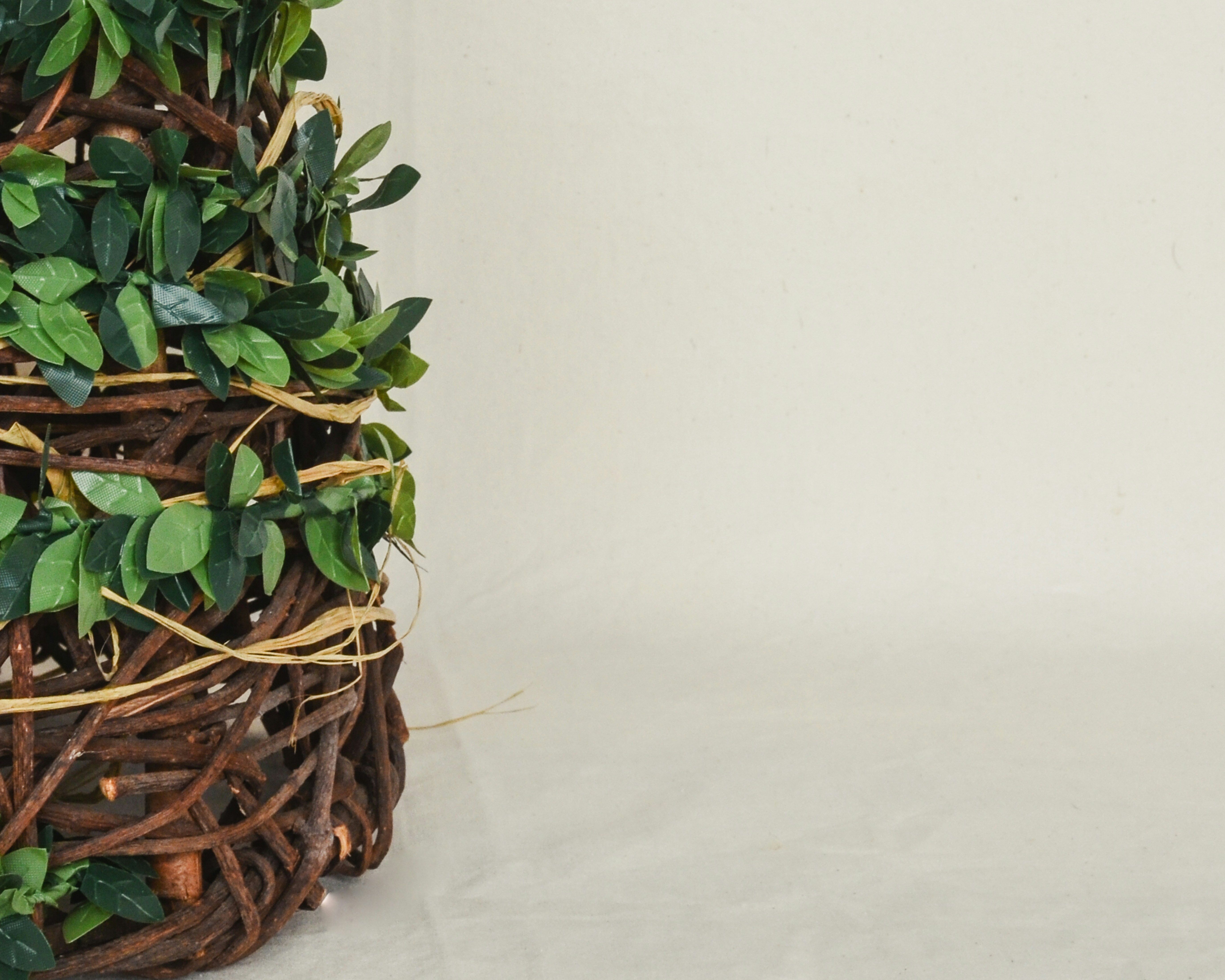 A basket filled with lots of green leaves