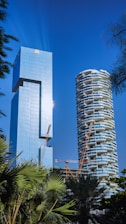 A tall building next to a palm tree