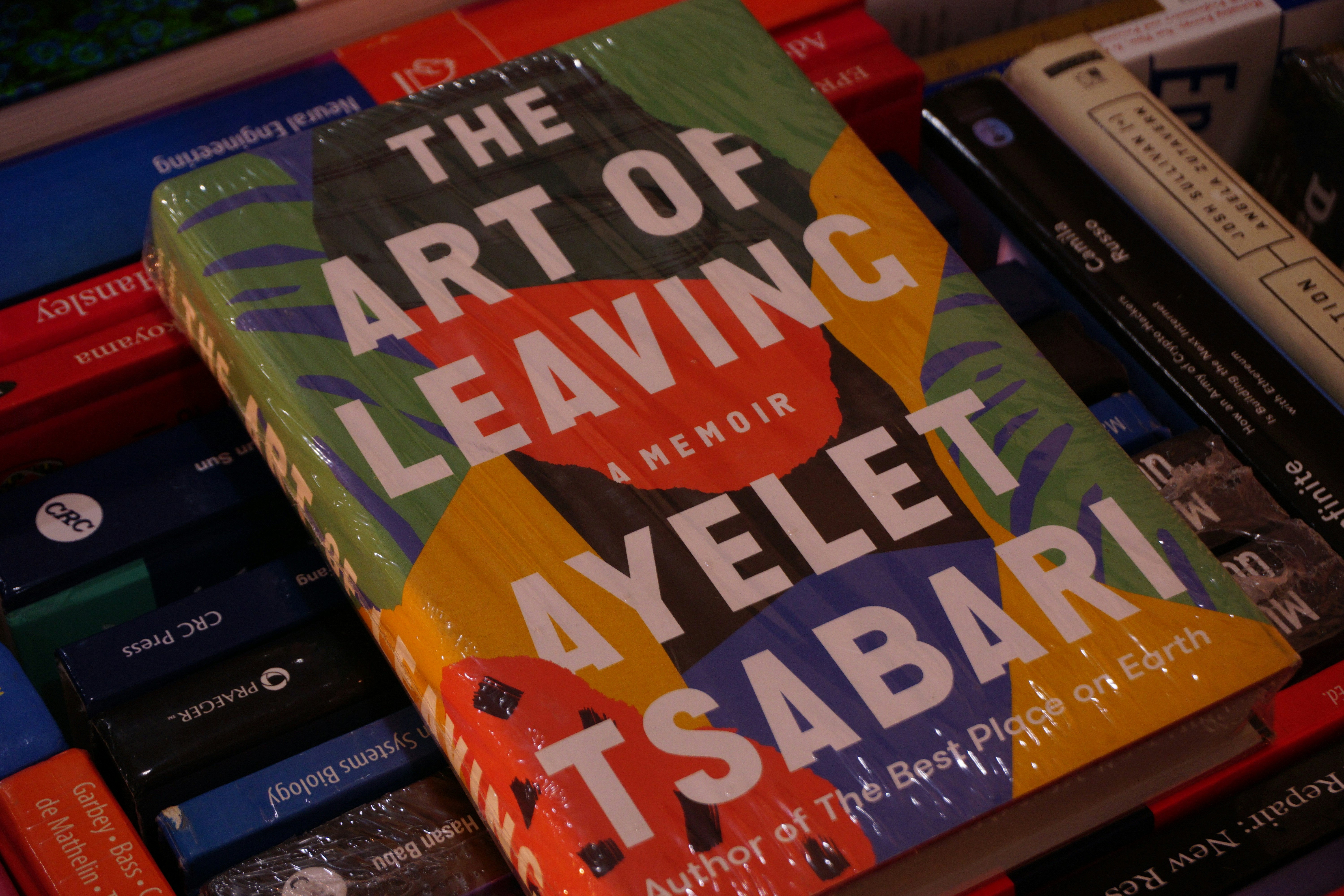 A book sitting on top of a pile of books