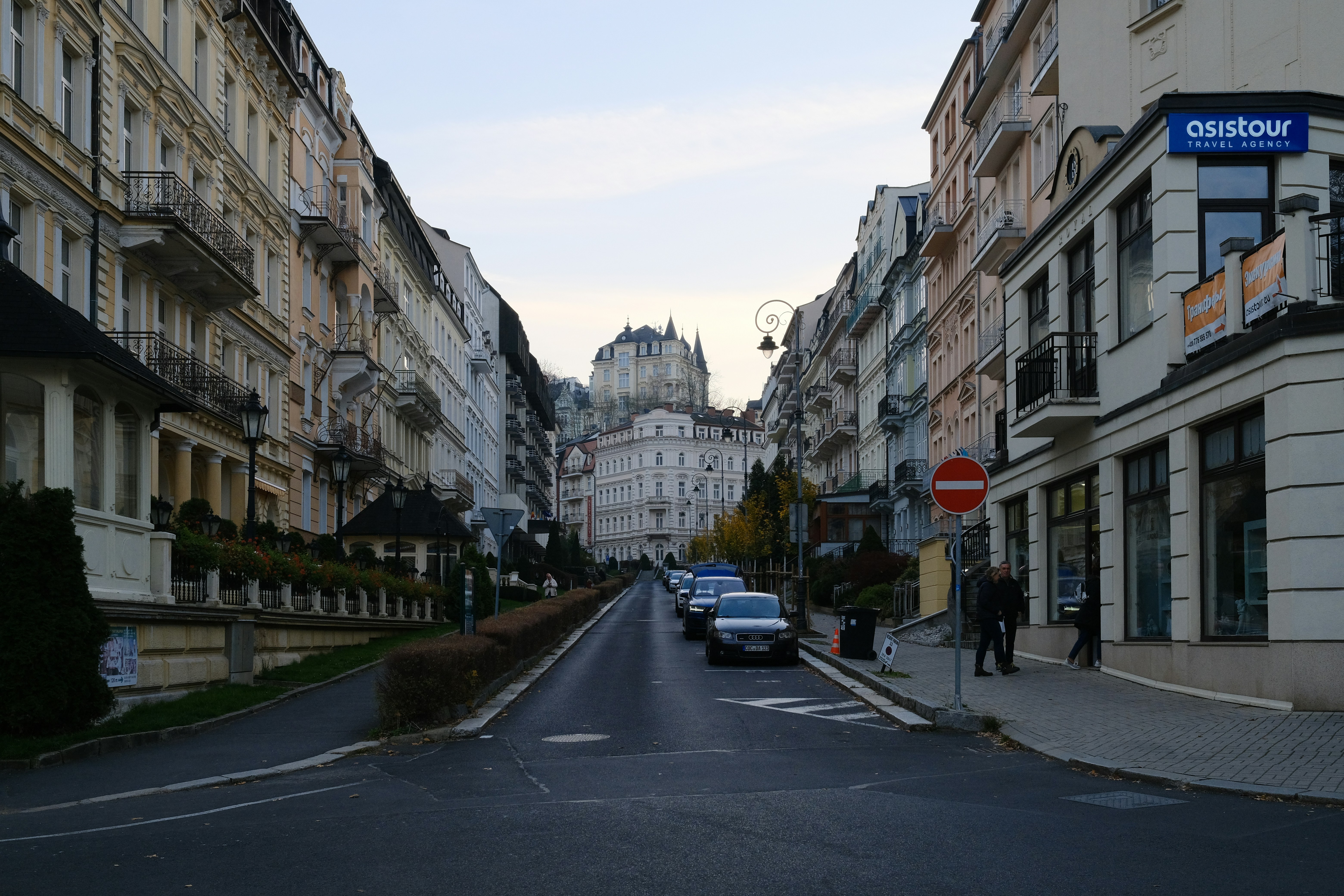 A city street with cars parked on both sides of it