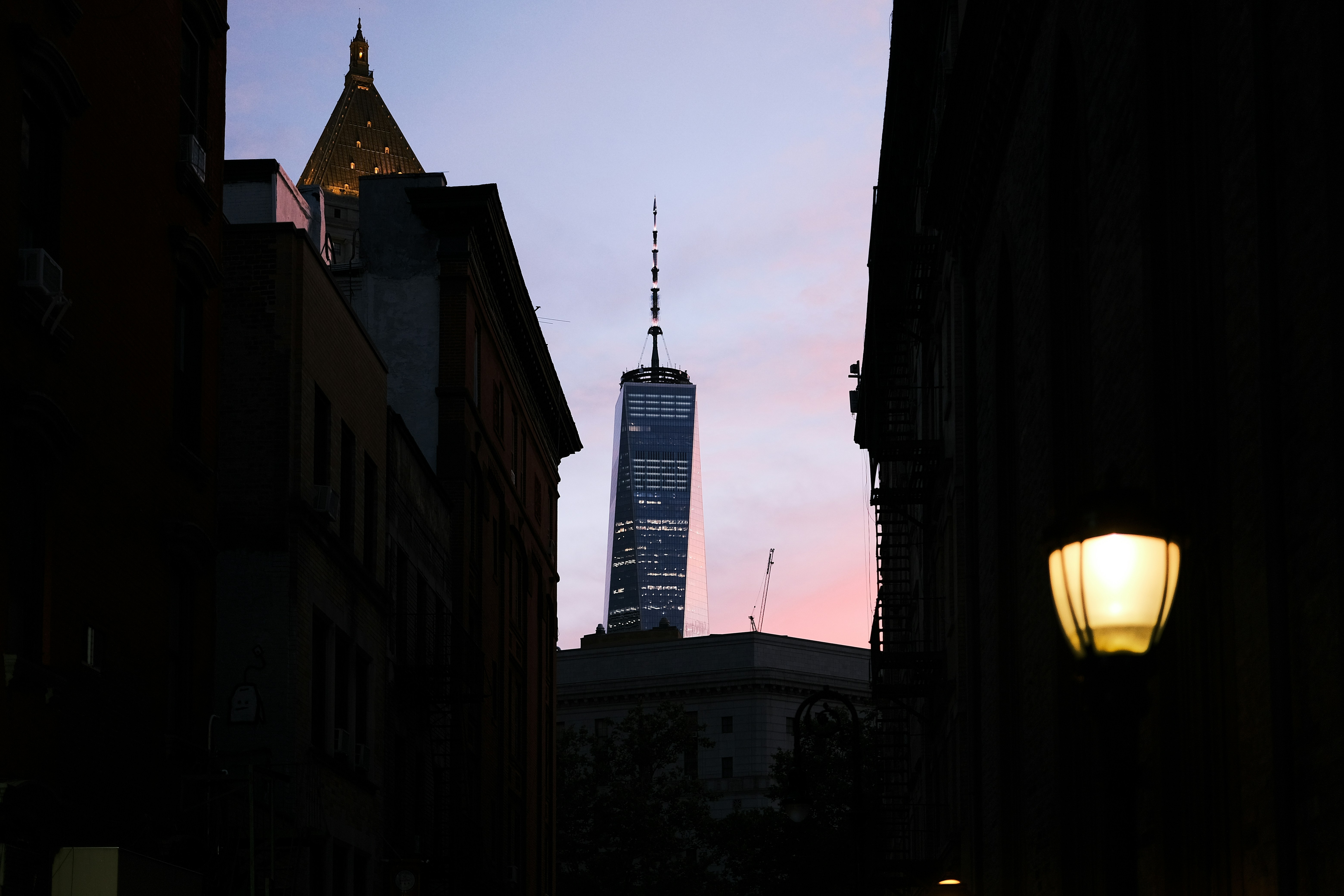 A city street with a tall building in the background