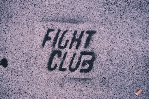 The word fight club is written on the sidewalk