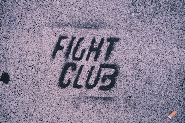 The word fight club is written on the sidewalk