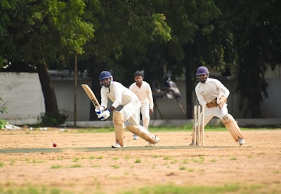 A group of men playing a game of cricket