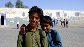 A couple of kids standing next to each other